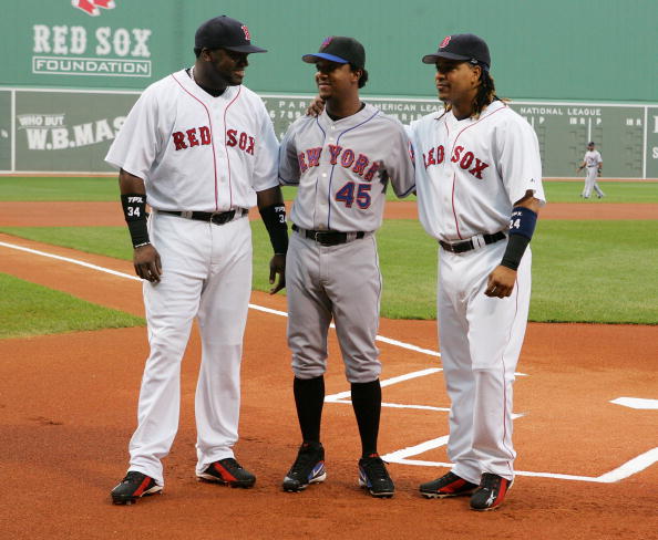 BOSTON - JUNE 29:  David Ortiz #34 (L) and Manny Ramirez #24 of the Boston Red Sox pose with former teammate Pedro Martinez #45 of the New York Mets before their game on June 29, 2006 at Fenway Park in Boston, Massachusetts.  (Photo by Jim McIsaac/Getty I