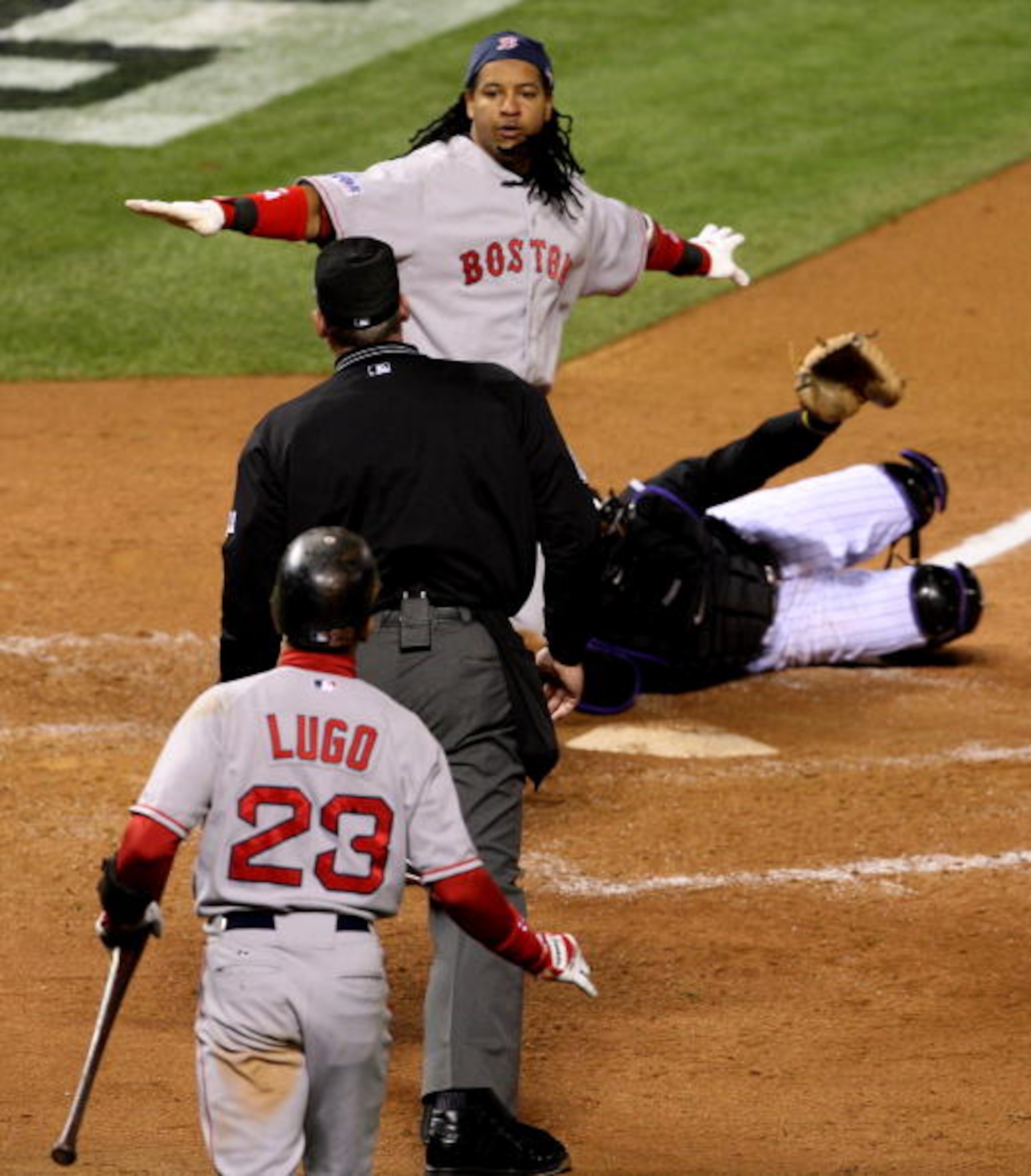 DENVER - OCTOBER 27:  Manny Ramirez #24 of the Boston Red Sox argues with home plate umpire Ted Barrett after Ramirez was called out on a play at theplate in the top of the third inning against the Colorado Rockies during Game Three of the 2007 Major Leag
