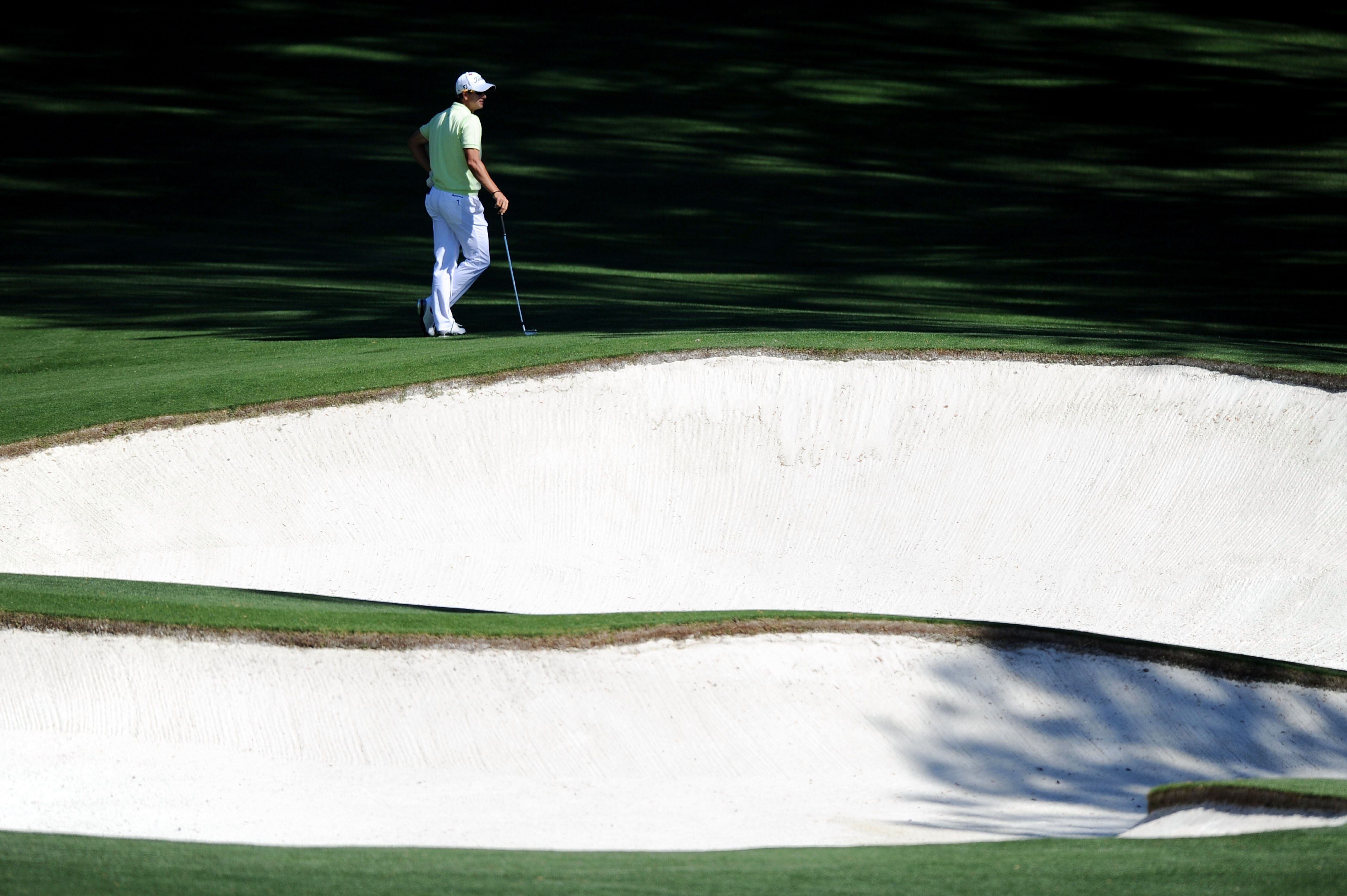 AUGUSTA, GA - APRIL 06:  Adam Scott of Australia waits near a bunker during a practice round prior to the 2011 Masters Tournament at Augusta National Golf Club on April 6, 2011 in Augusta, Georgia.  (Photo by Harry How/Getty Images)