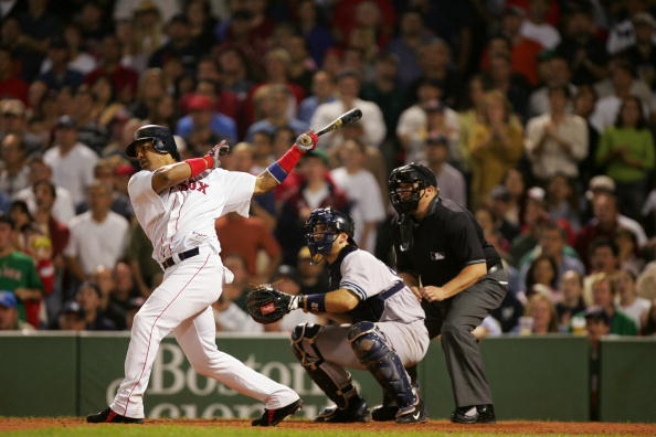BOSTON - SEPTEMBER 25:  Outfielder Manny Ramirez #24 of the Boston Red Sox follows through on a swing during the game with the New York Yankees on September 25, 2004 at Fenway Park in Boston, Massachusetts. The Red Sox won 12-5. (Photo by Ezra Shaw/Getty