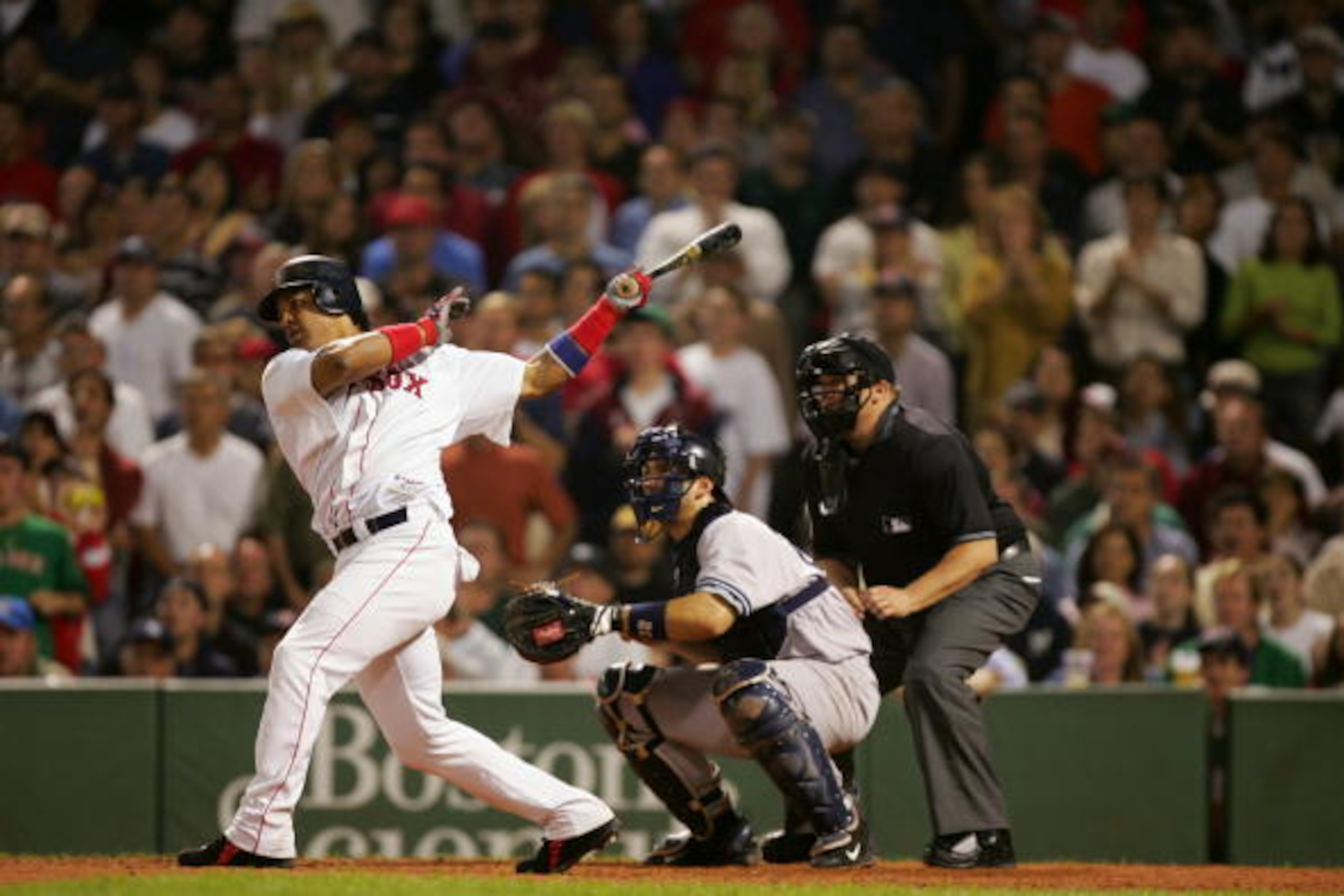 BOSTON - SEPTEMBER 25:  Outfielder Manny Ramirez #24 of the Boston Red Sox follows through on a swing during the game with the New York Yankees on September 25, 2004 at Fenway Park in Boston, Massachusetts. The Red Sox won 12-5. (Photo by Ezra Shaw/Getty