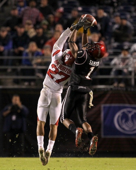 SAN DIEGO - NOVEMBER 20:  Wide receiver DeMarco Sampson #1 of the San Diego State Aztecs makes a catch over cornerback Brandon Burton #27 of the Utah Utes at Qualcomm Stadium on November 20, 2010 in San Diego, California.  Utah won 38-34.  (Photo by Steph