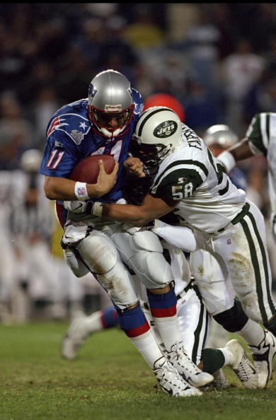 19 Oct 1998: Quarterback Drew Bledsoe #11 of the New England Patriots is sacked by James Farrior #58 of the New York Jets at Foxboro Stadium in Foxboro, Massachusetts. The Jets defeated the Patriots 24-14.
