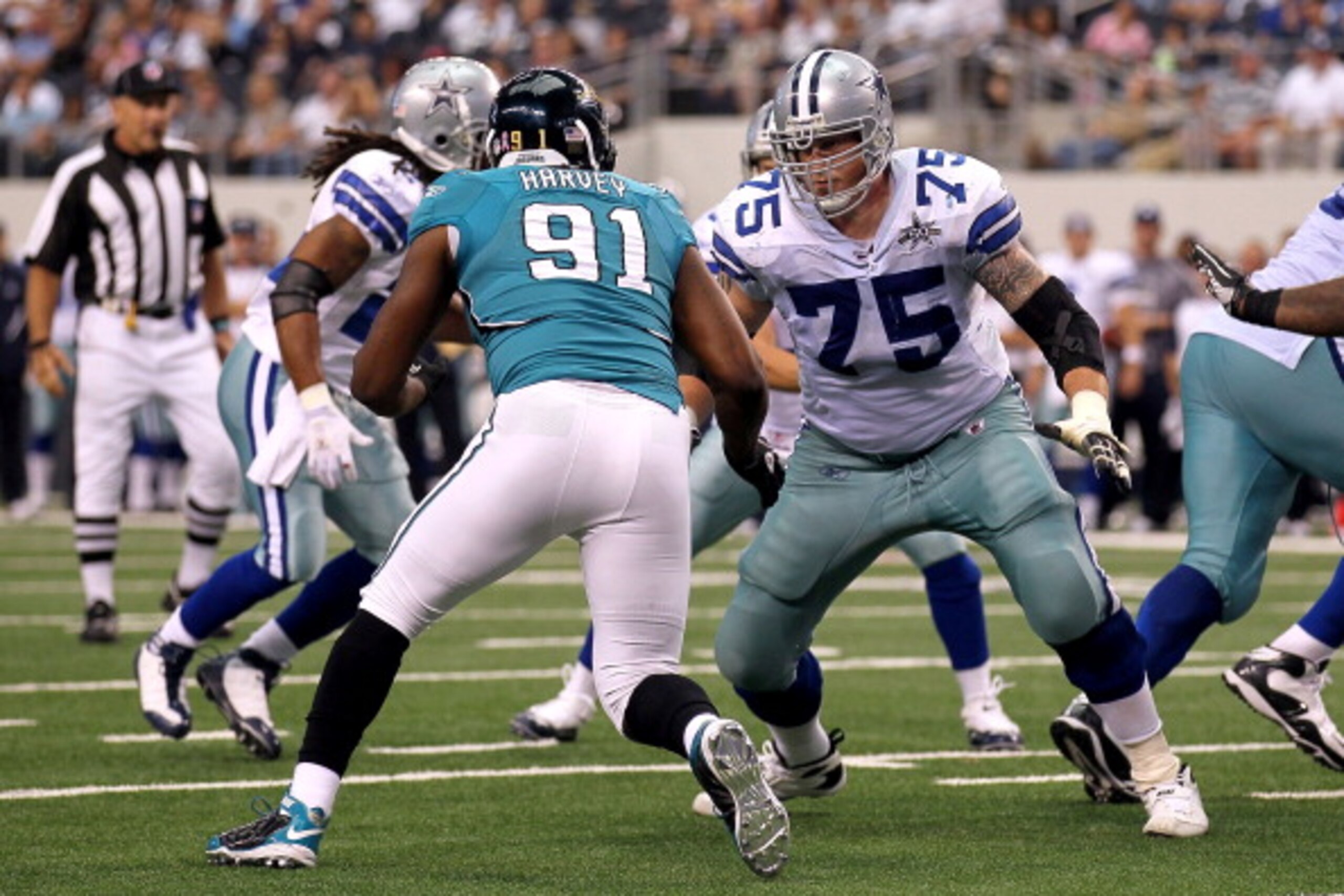 ARLINGTON, TX - OCTOBER 31: Offensive tackle Marc Colombo #75 of the Dallas Cowboys blocks against Derrick Harvey #91 of the Jacksonville Jaguars at Cowboys Stadium on October 31, 2010 in Arlington, Texas. (Photo by Stephen Dunn/Getty Images) ARLINGTON, TX - OCTOBER 31: Offensive tackle Marc Colombo #75 of the Dallas Cowboys blocks against Derrick Harvey #91 of the Jacksonville Jaguars at Cowboys Stadium on October 31, 2010 in Arlington, Texas. (Photo by Stephen Dunn/Getty Images)