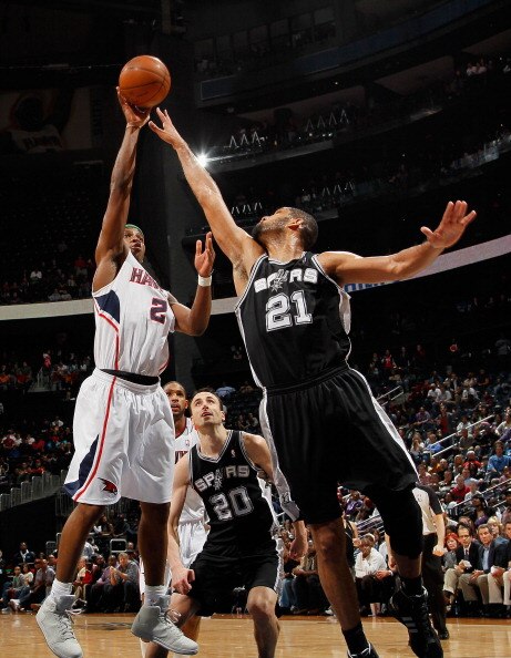 ATLANTA, GA - APRIL 05:  Joe Johnson #2 of the Atlanta Hawks shoots against Tim Duncan #21 of the San Antonio Spurs at Philips Arena on April 5, 2011 in Atlanta, Georgia.  NOTE TO USER: User expressly acknowledges and agrees that, by downloading and/or us