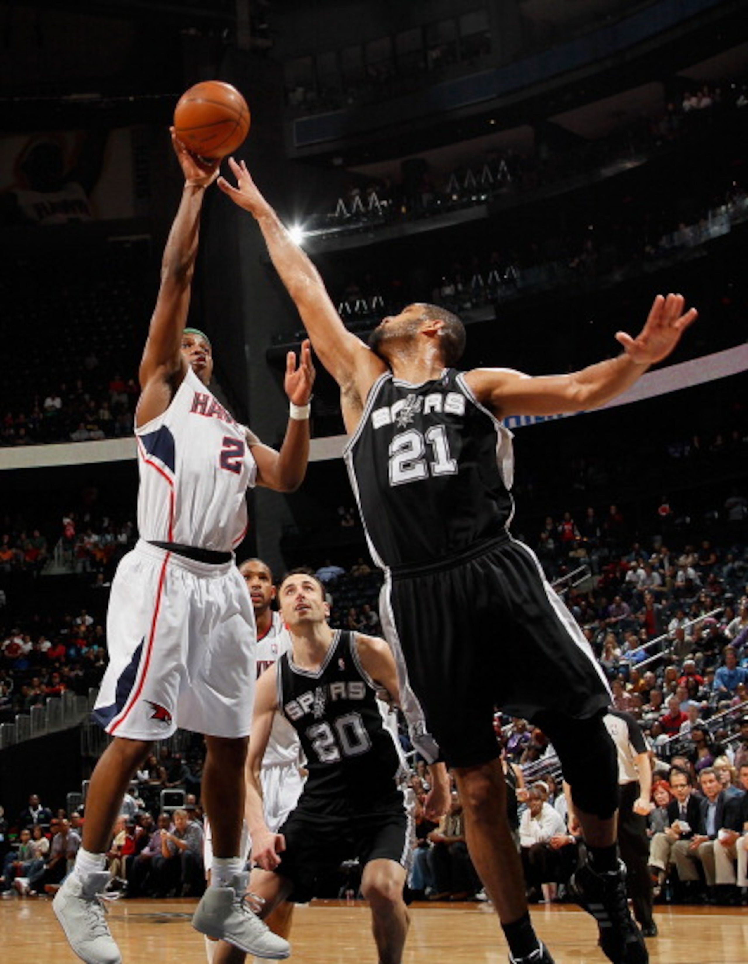 ATLANTA, GA - APRIL 05:  Joe Johnson #2 of the Atlanta Hawks shoots against Tim Duncan #21 of the San Antonio Spurs at Philips Arena on April 5, 2011 in Atlanta, Georgia.  NOTE TO USER: User expressly acknowledges and agrees that, by downloading and/or us