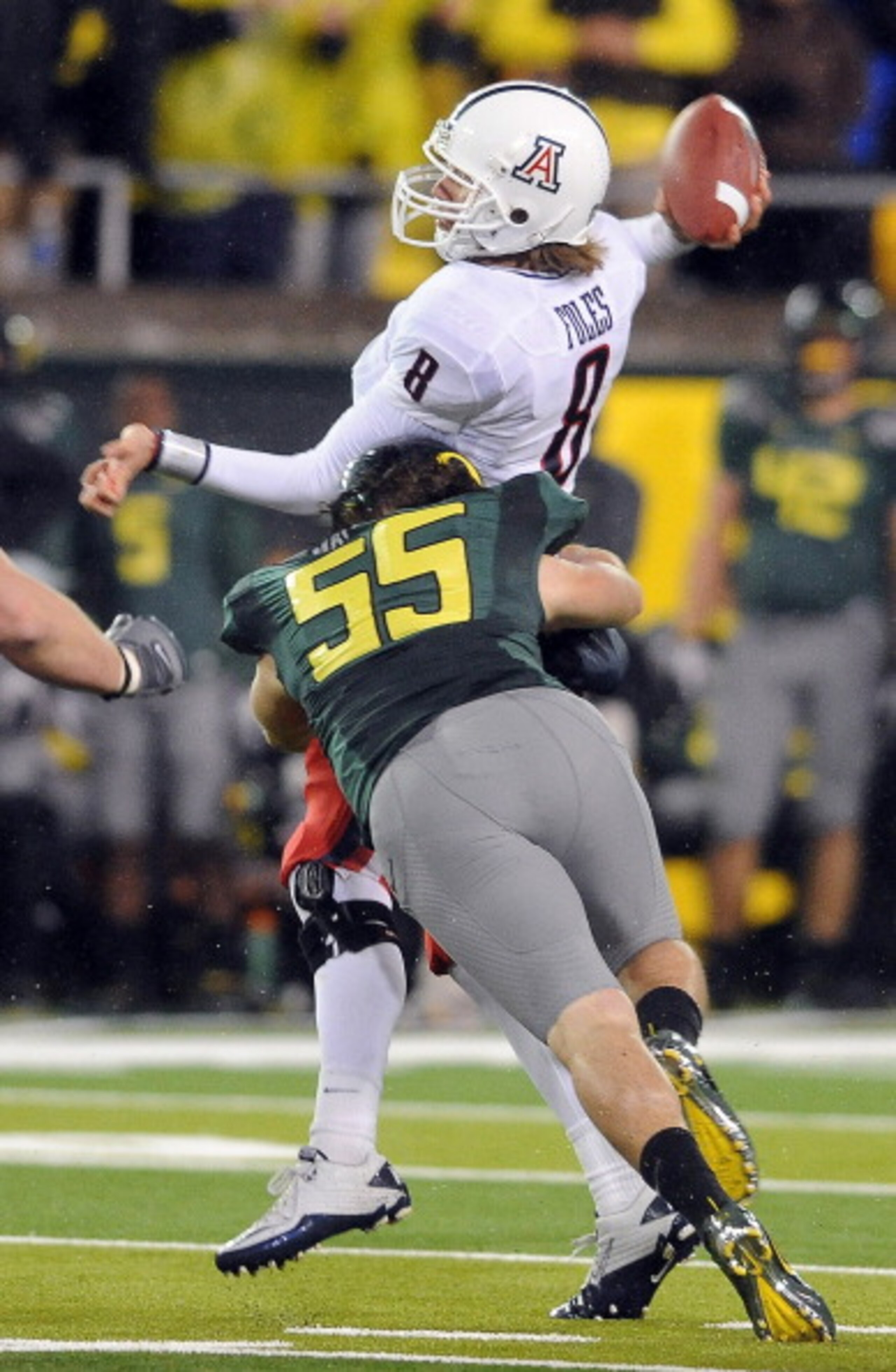 EUGENE, OR - NOVEMBER 26: Quarterback Nick Foles #8 of the Arizona Wildcats is hit by linebacker Casey Matthews #55 of the Oregon Ducks as he throws a pass in the third quarter of the game at Autzen Stadium on November 26, 2010 in Eugene, Oregon.The Ducks