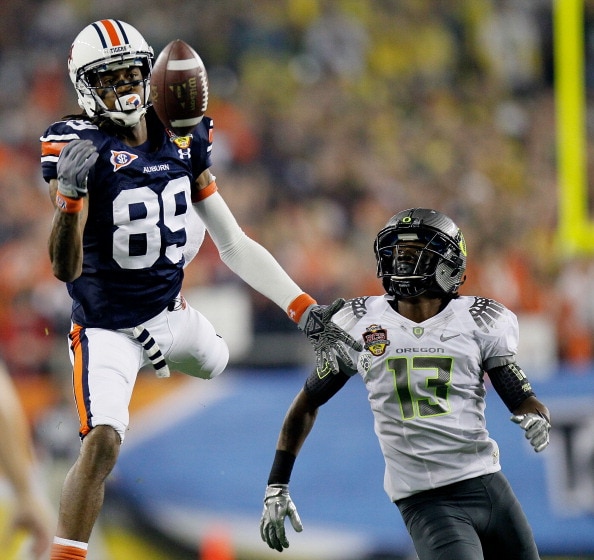 GLENDALE, AZ - JANUARY 10:  Darvin Adams #89 of the Auburn Tigers is unable to make a catch in the first half against Cliff Harris #13 of the Oregon Ducks during the Tostitos BCS National Championship Game at University of Phoenix Stadium on January 10, 2