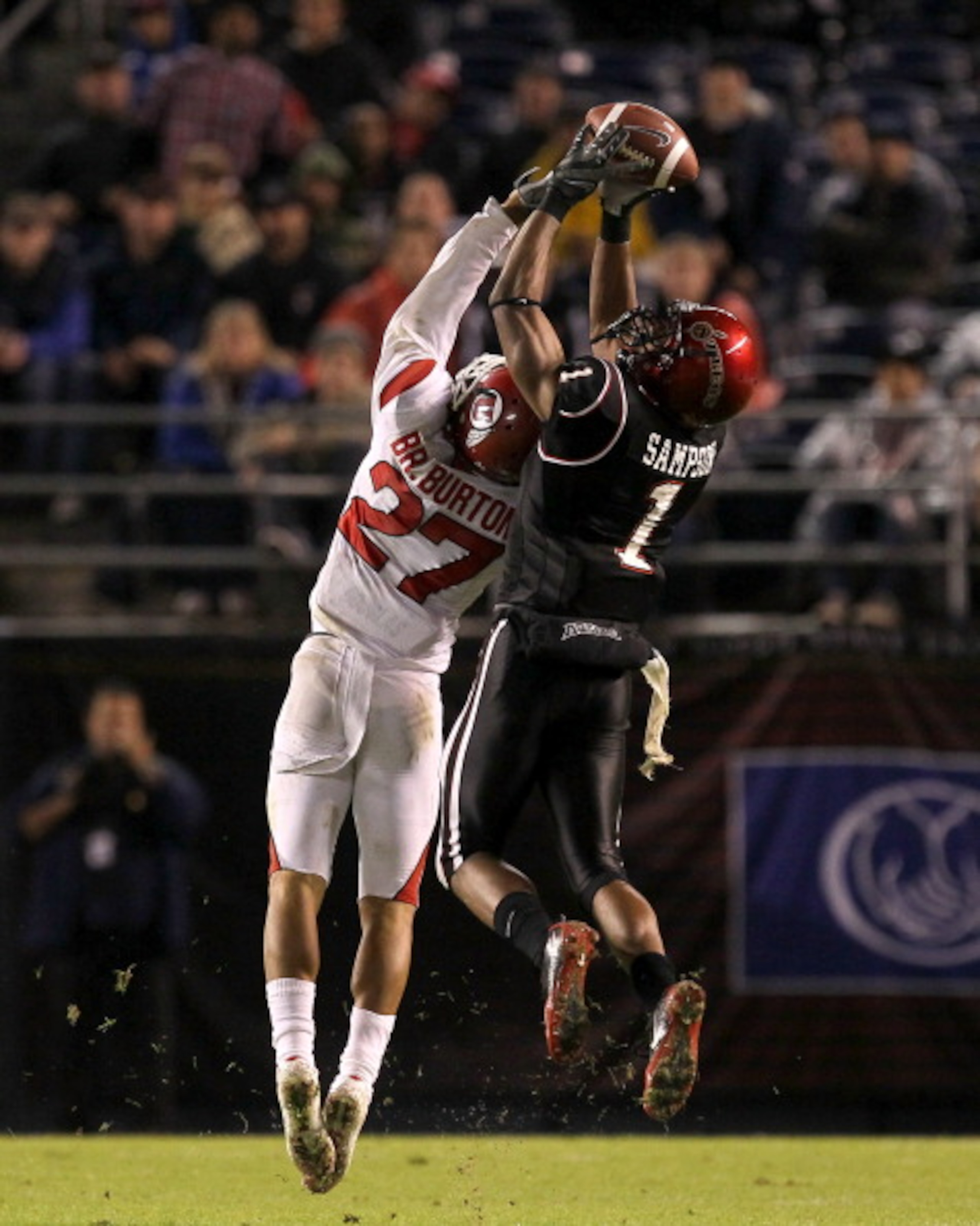 SAN DIEGO - NOVEMBER 20:  Wide receiver DeMarco Sampson #1 of the San Diego State Aztecs makes a catch over cornerback Brandon Burton #27 of the Utah Utes at Qualcomm Stadium on November 20, 2010 in San Diego, California.  Utah won 38-34.  (Photo by Steph