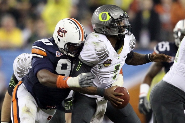 GLENDALE, AZ - JANUARY 10: Nick Fairley #90 of the Auburn Tigers sacks Darron Thomas #1 of the Oregon Ducks in the fourth quarter of the Tostitos BCS National Championship Game at University of Phoenix Stadium on January 10, 2011 in Glendale, Arizona. (Ph