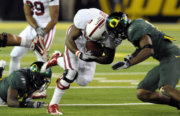 EUGENE, OR - OCTOBER 2: Wide receiver Chris Owusu #81 of the Stanford Cardinal is hit by free safety Javes Lewis #14 in the third quarter of the game at Autzen Stadium on October 2, 2010 in Eugene, Oregon. Owusu fumbled the ball and Oregon returned it for