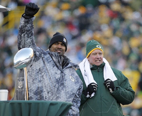 GREEN BAY, WI - FEBRUARY 08:  Green Bay Packers cornerback Charles Woodson and Defensive Coordinator Dom Capers take the stage to address the fans during the Packers victory celebration at Lambeau Field on February 8, 2011 in Green Bay, Wisconsin.  (Photo