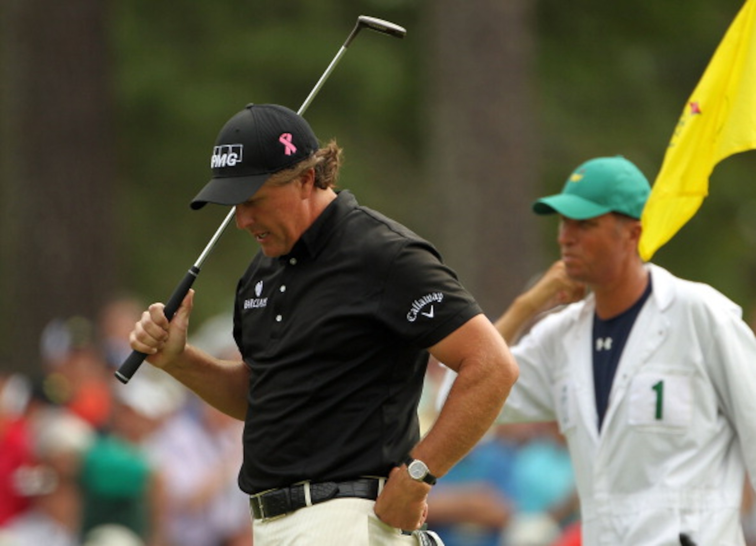 AUGUSTA, GA - APRIL 08:  Phil Mickelson reacts to dropping  stroke on the third hole as caddie Jim 'Bones' Mackay looks on during the second round of the 2011 Masters Tournament at Augusta National Golf Club on April 8, 2011 in Augusta, Georgia.  (Photo b