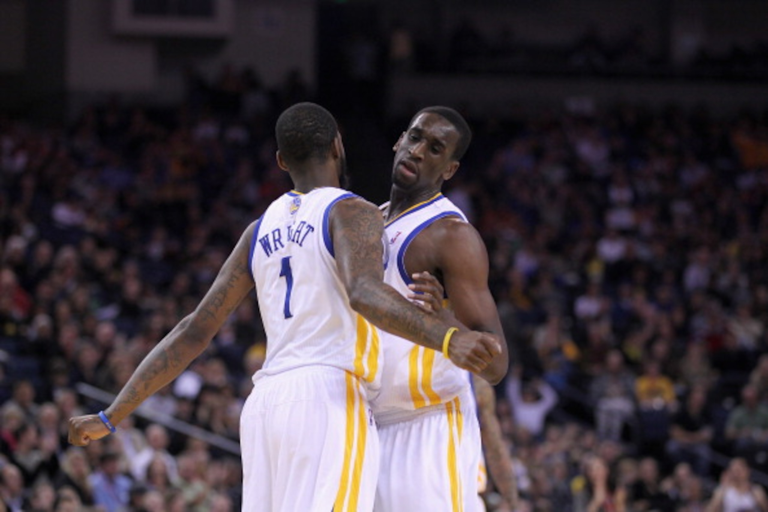 OAKLAND, CA - MARCH 25: Dorell Wright #1 of the Golden State Warriors is congratulated by Ekpe Udoh #20 of the Golden State Warriors after Wright made a basket during their game against the Toronto Raptors at Oracle Arena on March 25, 2011 in Oakland, Cal