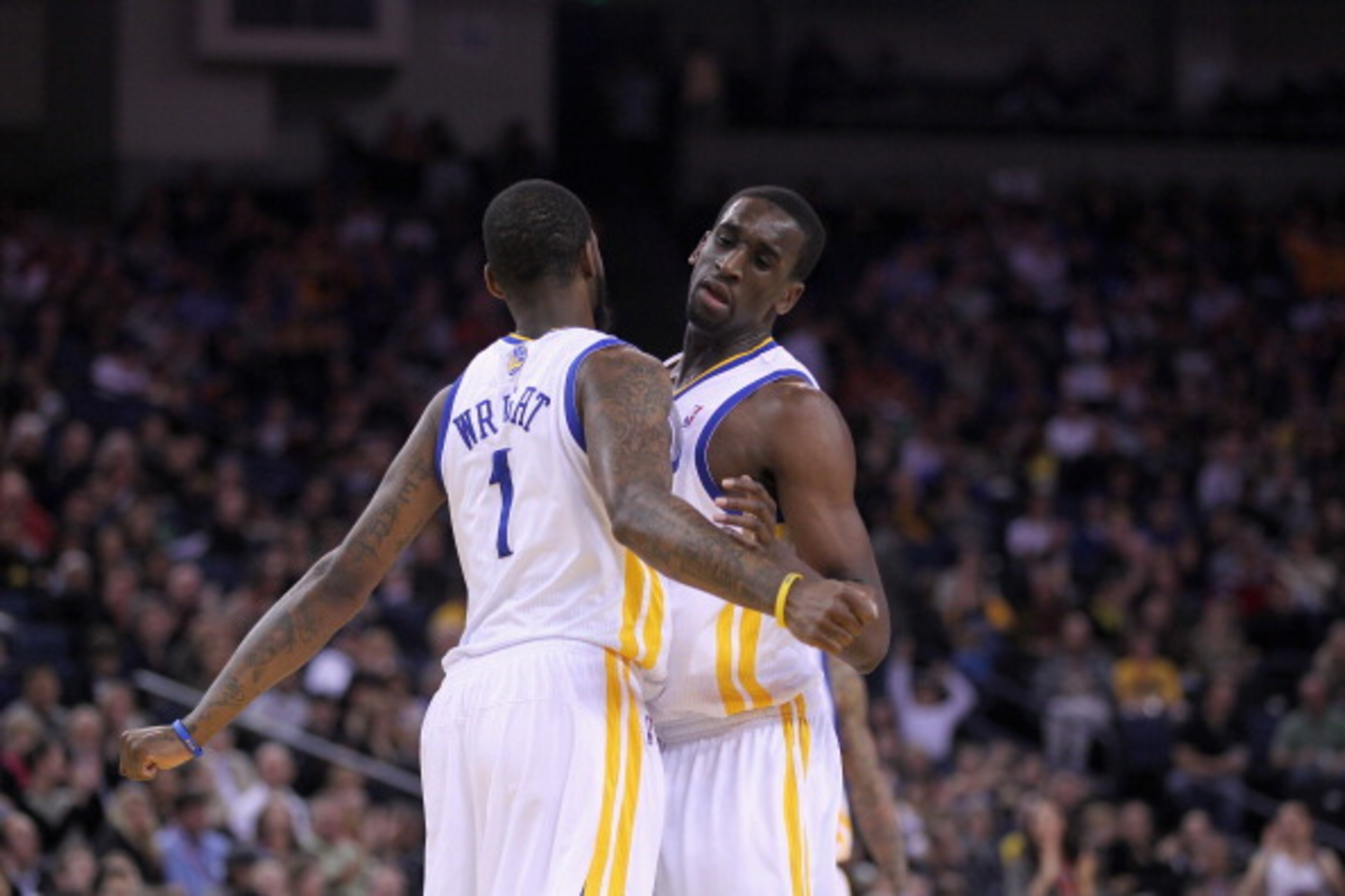 OAKLAND, CA - MARCH 25: Dorell Wright #1 of the Golden State Warriors is congratulated by Ekpe Udoh #20 of the Golden State Warriors after Wright made a basket during their game against the Toronto Raptors at Oracle Arena on March 25, 2011 in Oakland, Cal