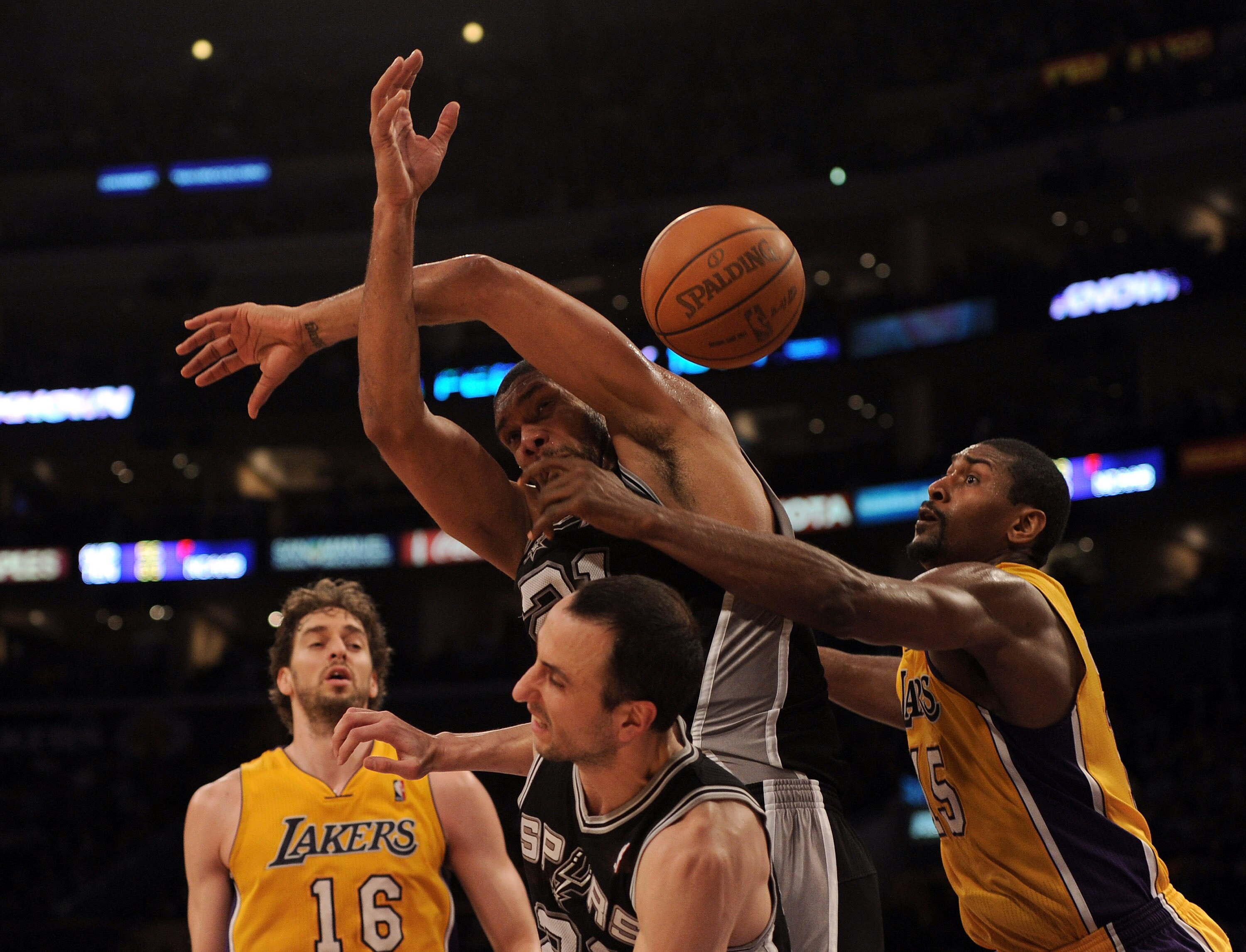 LOS ANGELES, CA - FEBRUARY 03:  Tim Duncan #21 of the San Antonio Spurs has the ball knocked away by Ron Artest #15 of the Los Angeles Lakers during the first half at Staples Center on February 3, 2011 in Los Angeles, California.  NOTE TO USER: User expre