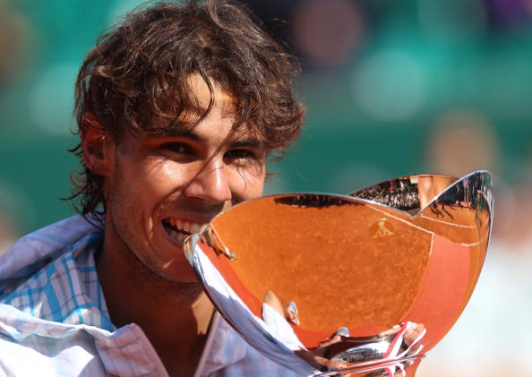 MONTE CARLO, MONACO - APRIL 18:  Rafael Nadal of Spain bites the trophy after defeating Fernando Verdasco of Spain in the final during day Seven of the ATP Masters Series at the Monte Carlo Country Club on April 18, 2010 in Monte Carlo, Monaco.  (Photo by