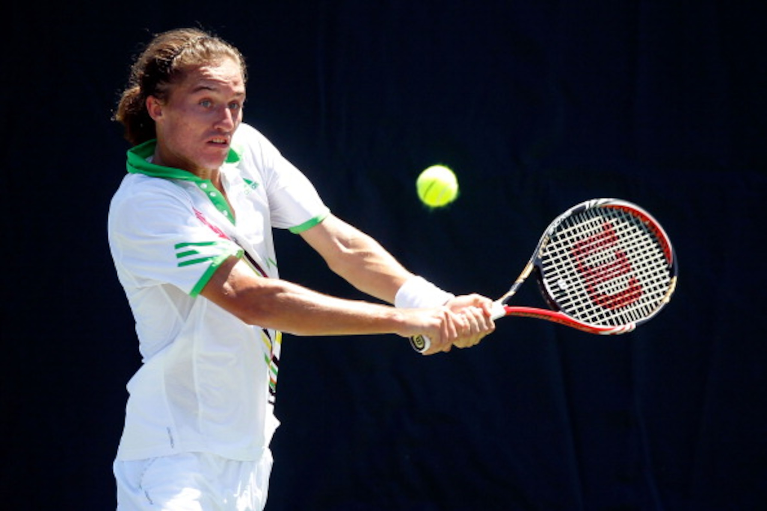 KEY BISCAYNE, FL - MARCH 26:  Alexandr Dolgopolov of the Ukraine returns against Andreas Seppi of Italy during the Sony Ericsson Open at Crandon Park Tennis Center on March 26, 2011 in Key Biscayne, Florida.  (Photo by Matthew Stockman/Getty Images)