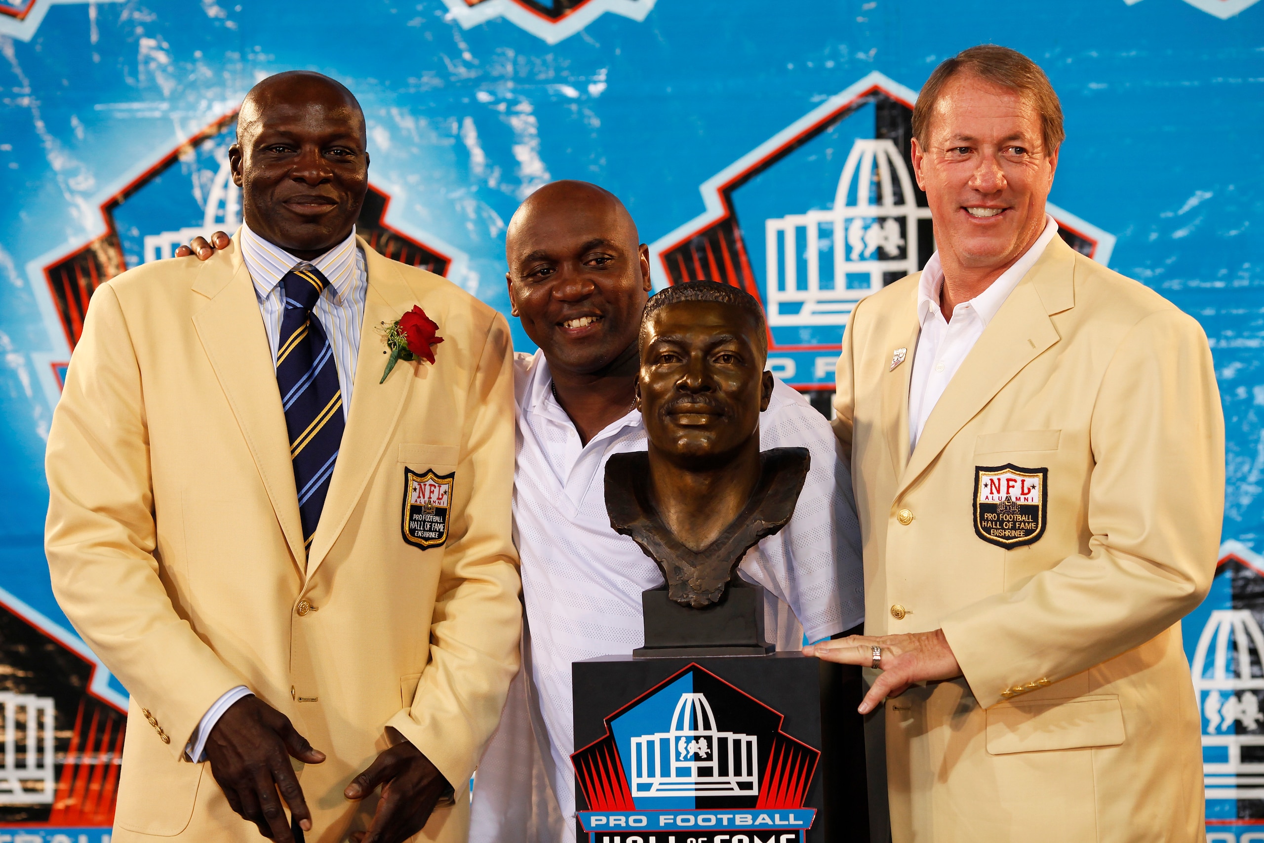 CANTON, OH - AUGUST 8: Bruce Smith looks on with former Buffalo Bills teammates Thurman Thomas (center) and Jim Kelly following his induction into the Pro Football Hall of Fame during the 2009 enshrinement ceremony at Fawcett Stadium on August 8, 2009 in
