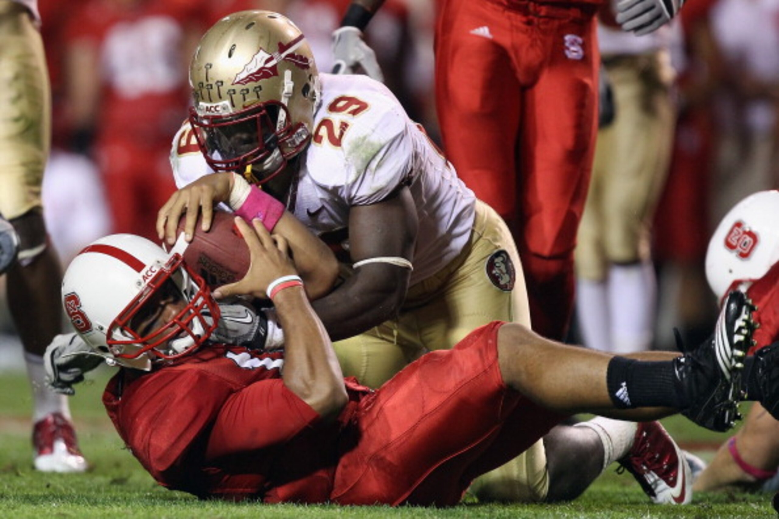 RALEIGH, NC - OCTOBER 28: Kendall Smith #29 of the Florida State Seminoles tackles Russell Wilson #16 of the North Carolina State Wolfpack during their game at Carter-Finley Stadium on October 28, 2010 in Raleigh, North Carolina. (Photo by Streeter Leck RALEIGH, NC - OCTOBER 28: Kendall Smith #29 of the Florida State Seminoles tackles Russell Wilson #16 of the North Carolina State Wolfpack during their game at Carter-Finley Stadium on October 28, 2010 in Raleigh, North Carolina. (Photo by Streeter Leck