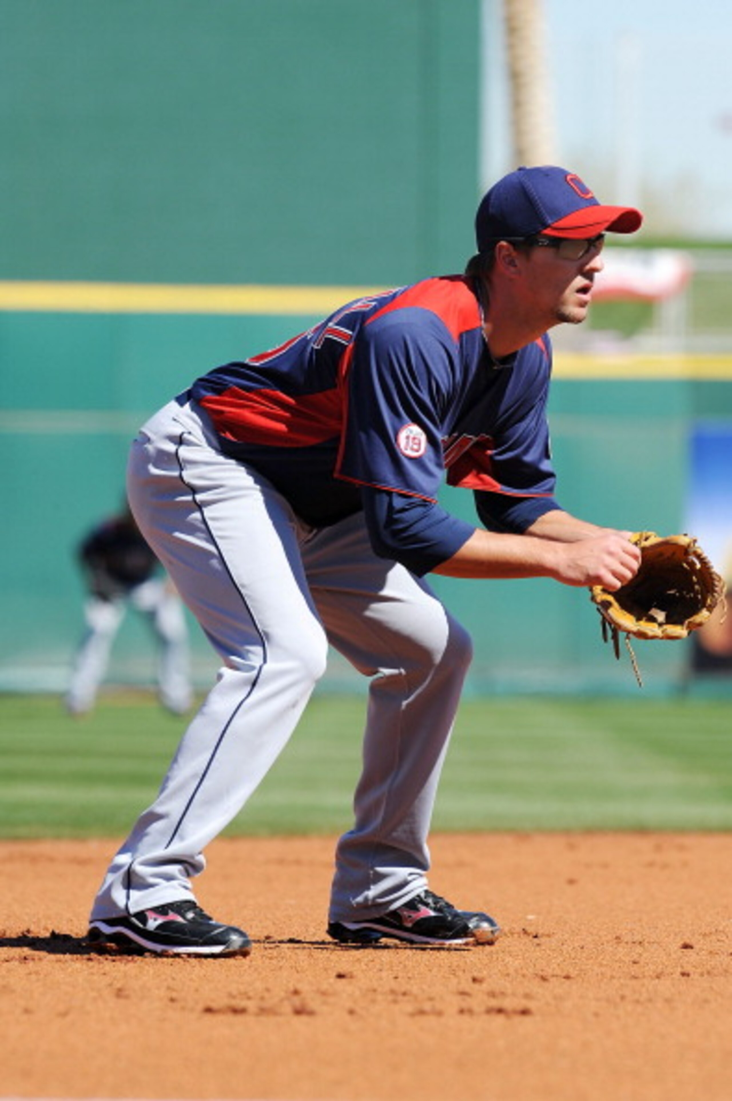 GOODYEAR, AZ - FEBRUARY 28:  Lonnie Chisenhall #76 of the Cleveland Indians gets ready to make a play at third base against the Cincinnati Reds at Goodyear Ballpark on February 28, 2011 in Goodyear, Arizona.  (Photo by Norm Hall/Getty Images)