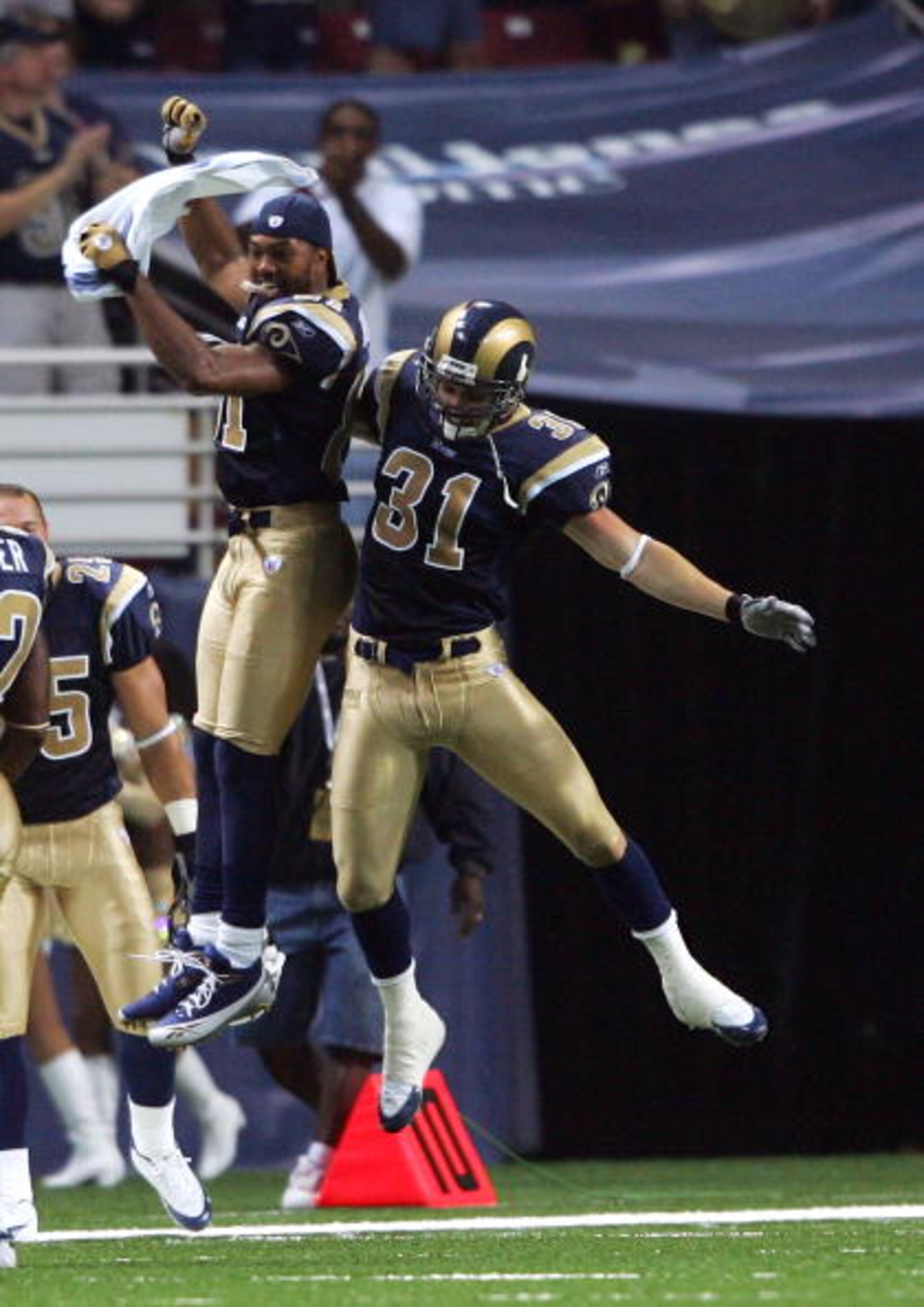 ST. LOUIS - SEPTEMBER 25:  Adam Archuleta #31 of the St. Louis Rams celebrates his touchdown with teammate Torry Holt #81 in the first half against the Tennessee Titans on September 25, 2005 at the Edward Jones Dome in St. Louis, Missouri. Archuleta inter