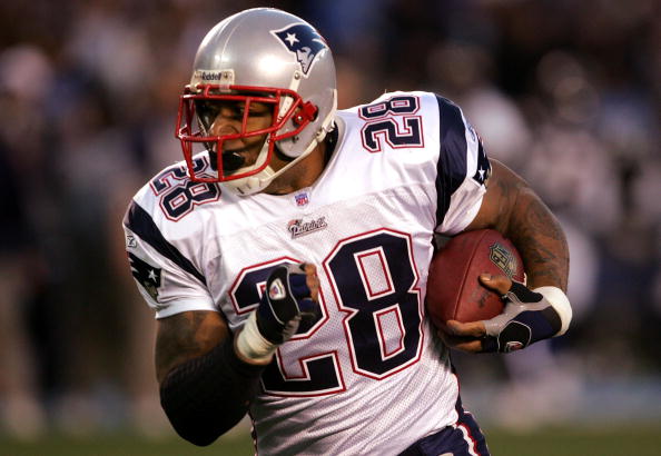 SAN DIEGO - JANUARY 14:  Runningback Corey Dillon #28 of the New England Patriots carries the ball against the San Diego Chargers during the AFC Divisional Playoff Game held at Qualcomm Stadium January 14, 2007 in San Diego, California. The Patriots defea