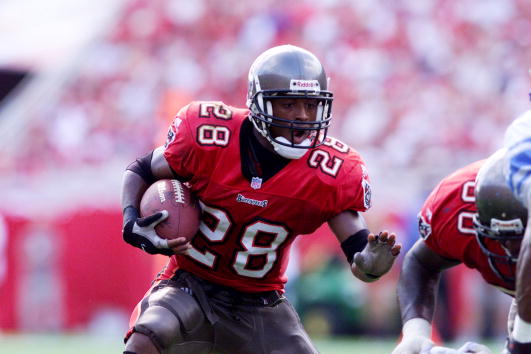 9 Dec 2001:  Warrick Dunn #28 of the Tampa Bay Buccaneers runs against the defense of the Detroit Lions during the game at Raymond James Stadium in Tampa, Florida. The Buccaneers won 15-12. DIGITAL IMAGE. Mandatory Credit: Andy Lyons/ALLSPORT