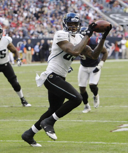 HOUSTON - JANUARY 02:  Wide receiver Mike Thomas #80 of the Jacksonville Jaguars scores in the second quarter against the Houston Texans at Reliant Stadium on January 2, 2011 in Houston, Texas.  (Photo by Bob Levey/Getty Images)