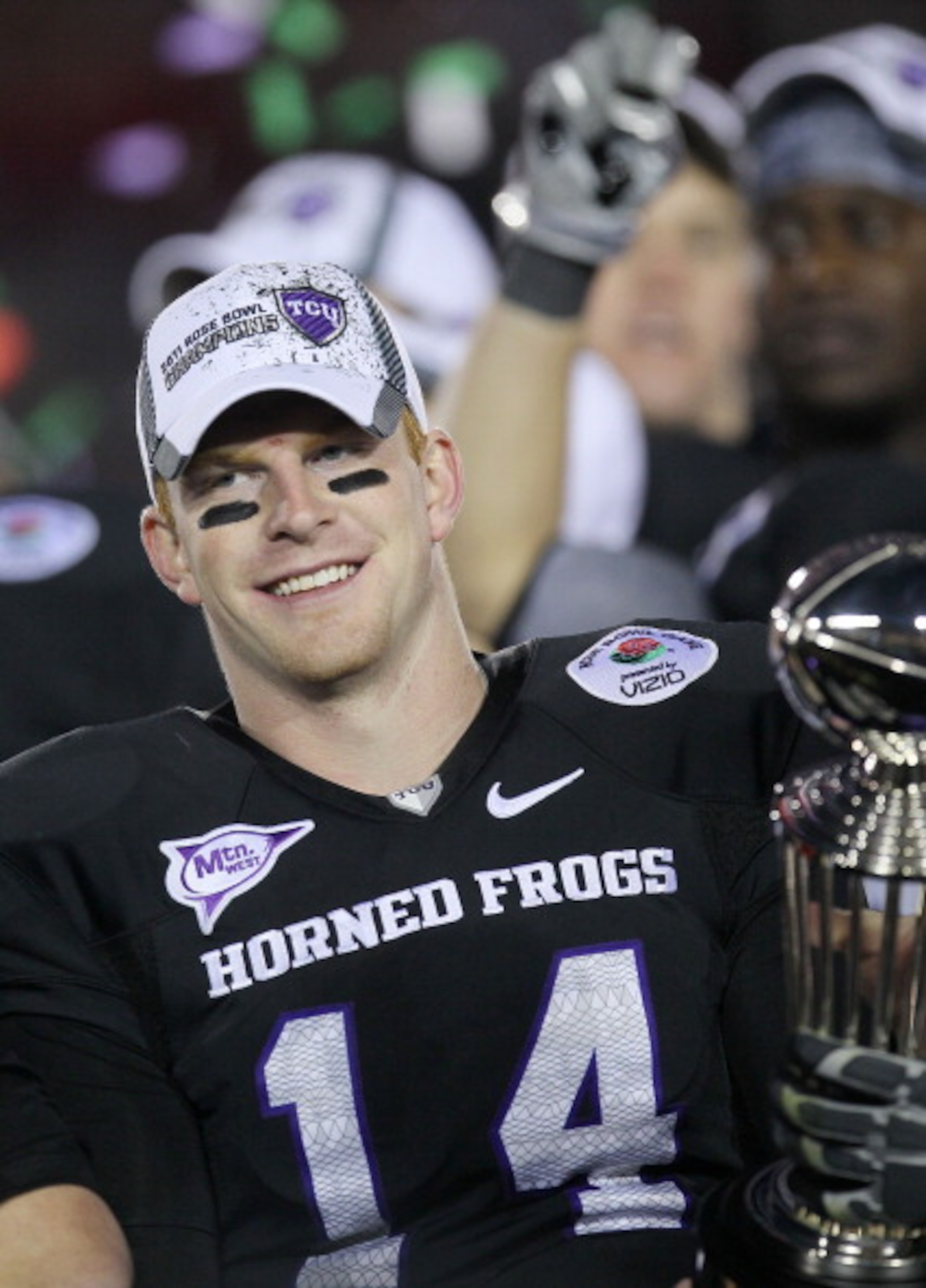 PASADENA, CA - JANUARY 01:  Quarterback Andy Dalton #14 of the TCU Horned Frogs celebrates with the Rose Bowl Championship Trophy after defeating the Wisconsin Badgers 21-19 in the 97th Rose Bowl game on January 1, 2011 in Pasadena, California.  (Photo by