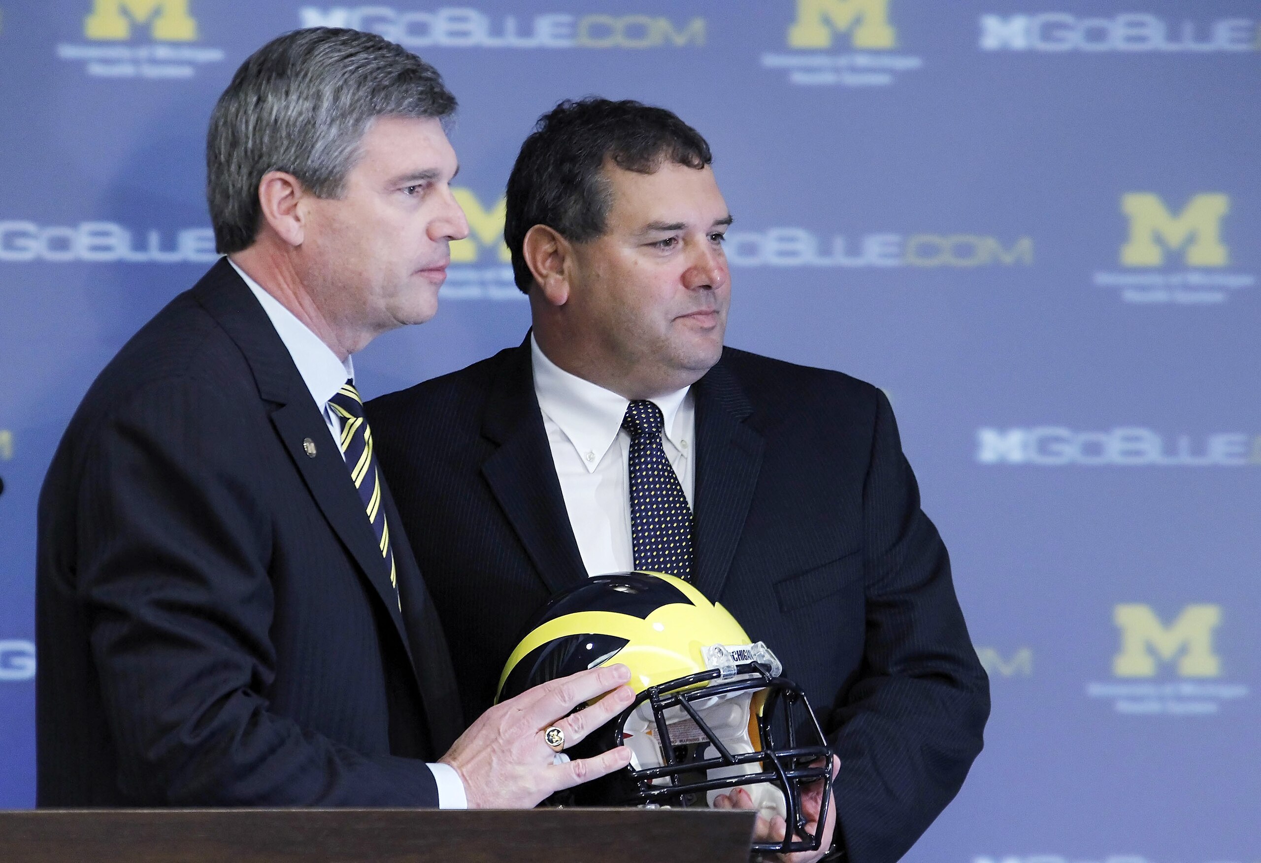 ANN ARBOR, MI - JANUARY 12:  New University of Michigan head football coach Brady Hoke (R) stands with Athletic Director Dave Brandon after being introduced to the media at the Junge Family Champions Center on January 12, 2011 in Ann Arbor, Michigan.  (Ph