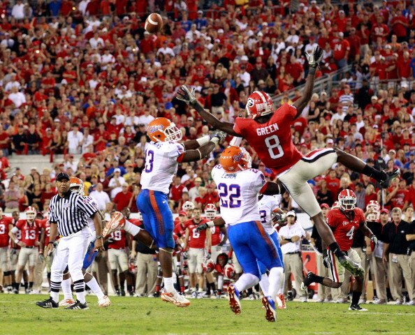 JACKSONVILLE, FL - OCTOBER 30:  A.J. Green #8 of the Georgia Bulldogs attempts to catch a pass against Jelani Jenkins #43 and Matt Elam #22 of the Florida Gators during the game at EverBank Field on October 30, 2010 in Jacksonville, Florida.  (Photo by Sa