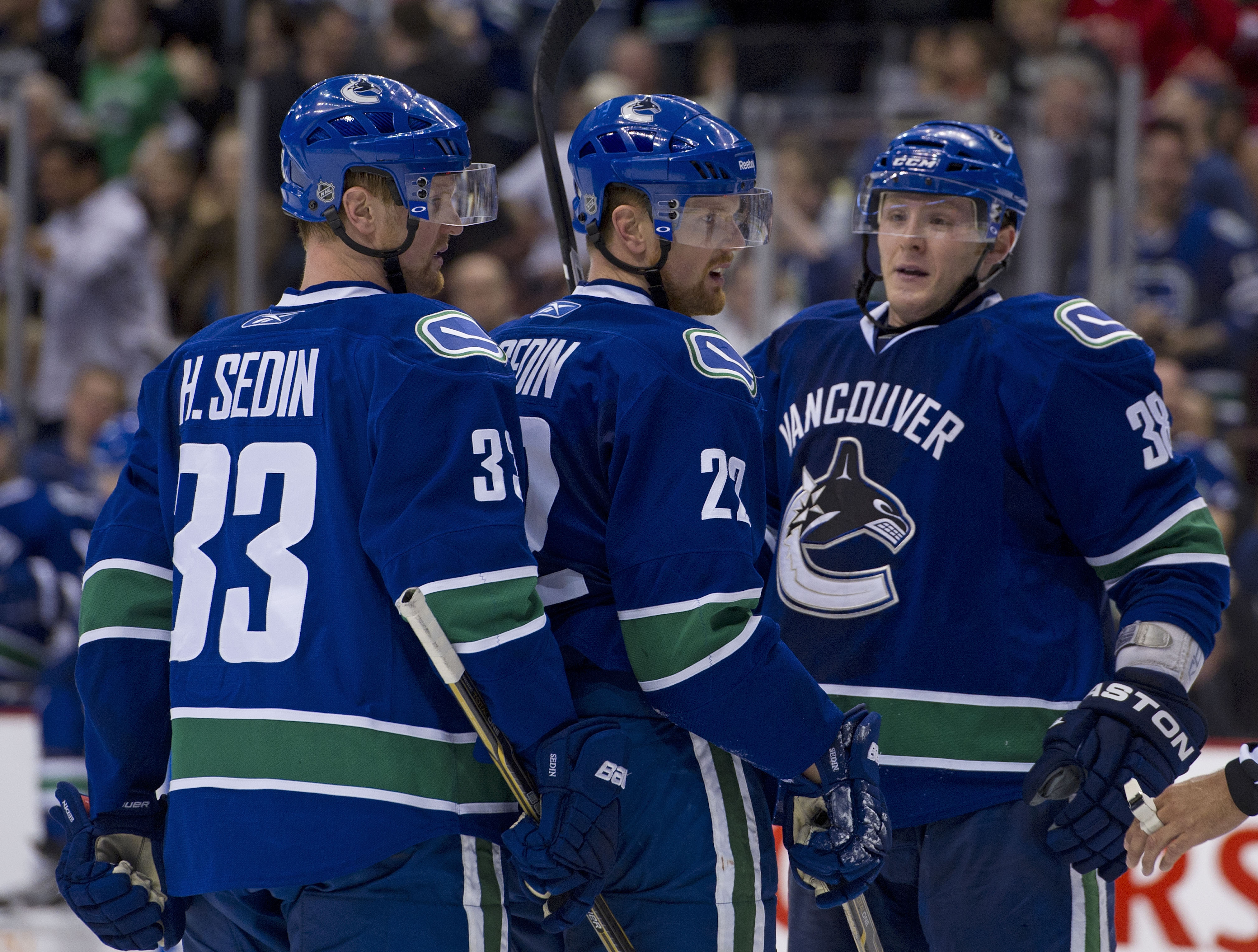 VANCOUVER, CANADA - MARCH 31: Daniel Sedin #22 of the Vancouver Canucks is congratulated by Henrik Sedin #33 and Victor Oreskovich #38 after scoring against the Los Angeles Kings during the second period in NHL action on March 31, 2011 at Rogers Arena in