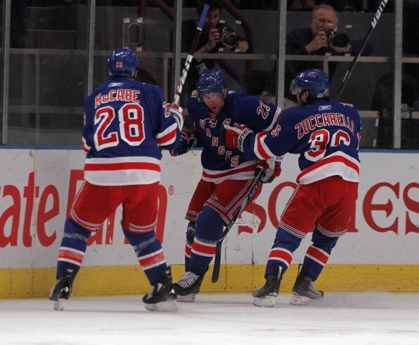 NEW YORK, NY - APRIL 09: Chris Drury #23 of the New York Rangers scores a first period goal and is joined by Bryan McCabe #28 and Mats Zuccarello #36 in their game against the New Jersey Devils at Madison Square Garden on April 9, 2011 in New York City.