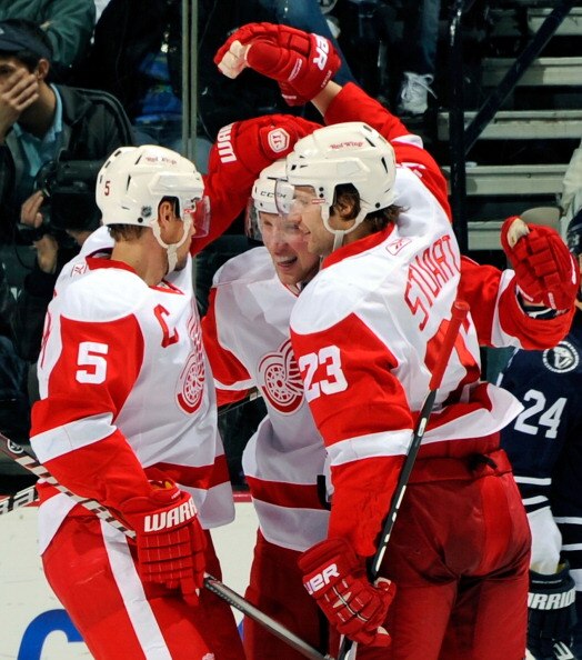 NASHVILLE, TN - APRIL 02:  Nicklas Lidstrom #5 and Brad Stuart #23 of the Detroit Red Wings congratulate Jonathan Ericsson #52 on scoring a goal against the Nashville Predators on April 2, 2011 at the Bridgestone Arena in Nashville, Tennessee.  (Photo by