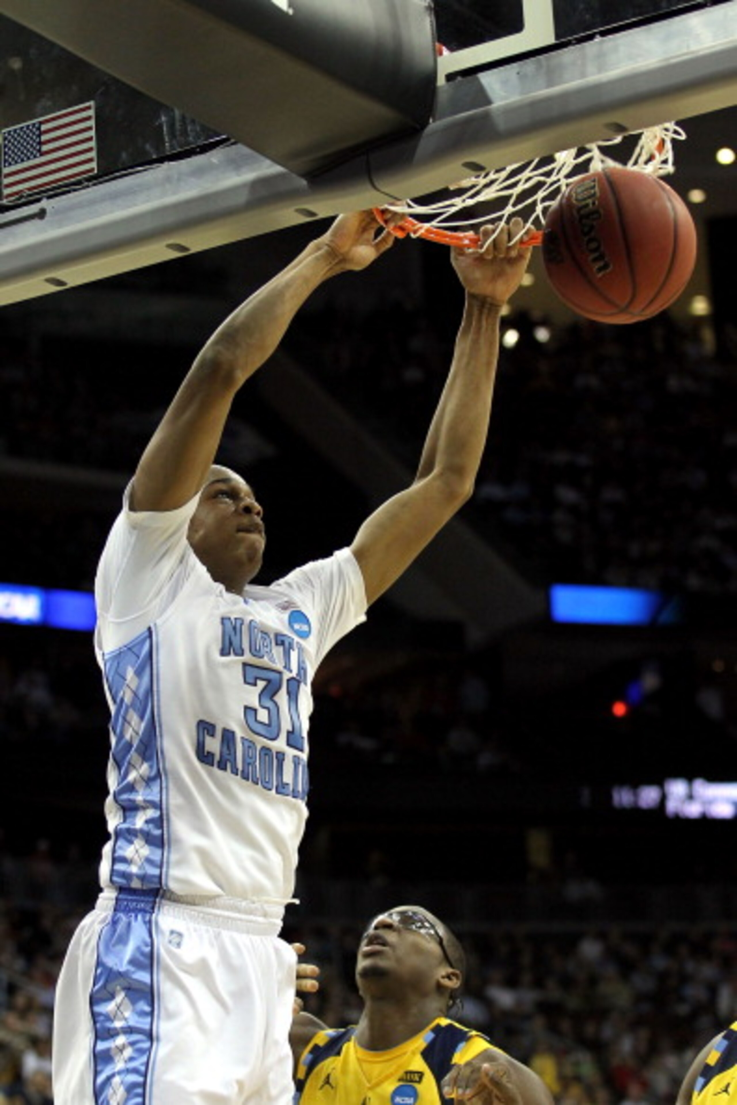NEWARK, NJ - MARCH 25: John Henson #31 of the North Carolina Tar Heels dunks against the Marquette Golden Eagles during the east regional semifinal of the 2011 NCAA Men's Basketball Tournament at the Prudential Center on March 25, 2011 in Newark, New Jer NEWARK, NJ - MARCH 25: John Henson #31 of the North Carolina Tar Heels dunks against the Marquette Golden Eagles during the east regional semifinal of the 2011 NCAA Men's Basketball Tournament at the Prudential Center on March 25, 2011 in Newark, New Jer
