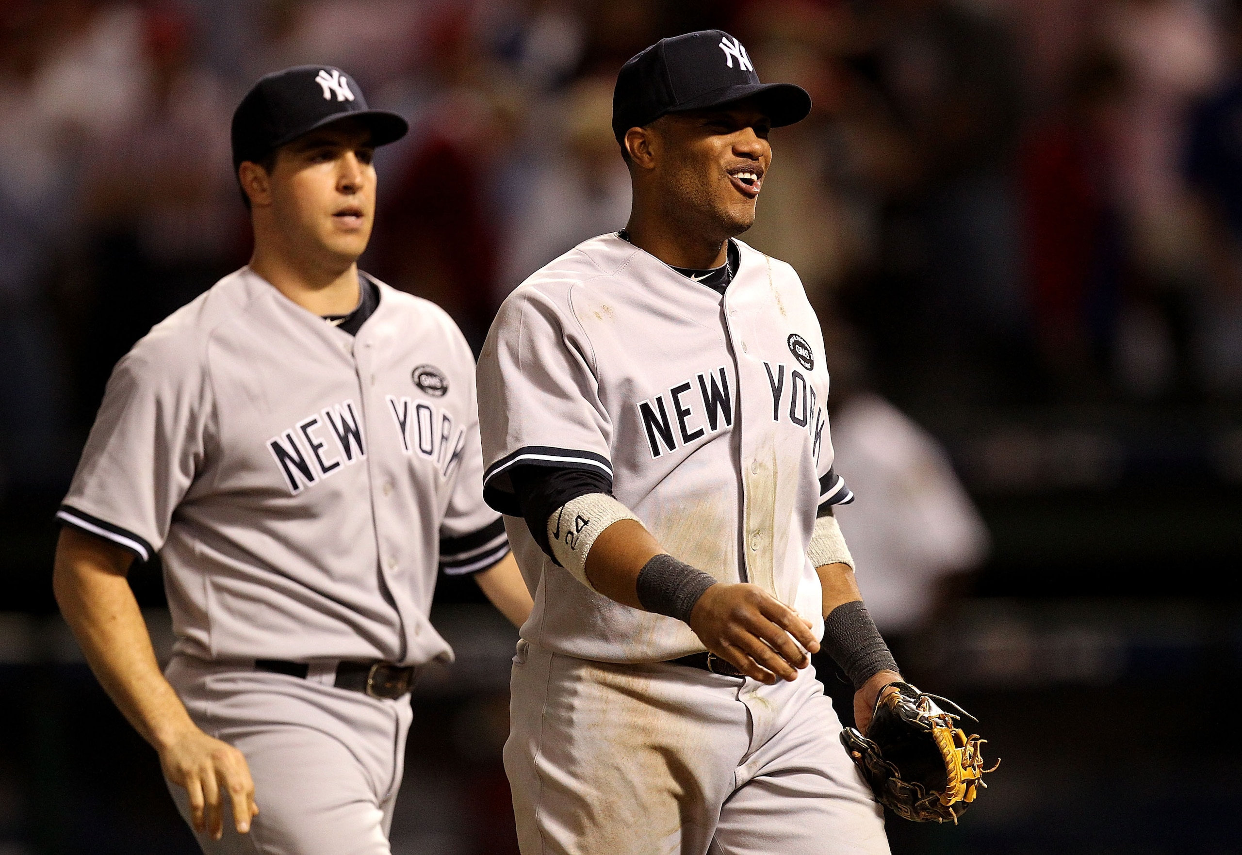 ARLINGTON, TX - OCTOBER 15: Robinson Cano #24 (R) and Mark Teixeira #25 of the New York Yankees react after their 6-5 win against the Texas Rangers in Game One of the ALCS during the 2010 MLB Playoffs at Rangers Ballpark in Arlington on October 15, 2010 ARLINGTON, TX - OCTOBER 15: Robinson Cano #24 (R) and Mark Teixeira #25 of the New York Yankees react after their 6-5 win against the Texas Rangers in Game One of the ALCS during the 2010 MLB Playoffs at Rangers Ballpark in Arlington on October 15, 2010