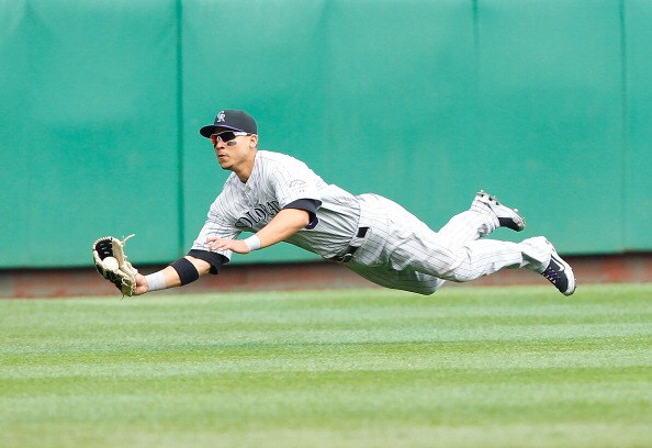 PITTSBURGH - APRIL 07:  Carlos Gonzalez #5 of the Colorado Rockies makes a diving catch during the Opening Day game against the Pittsburgh Pirates on April 7, 2011 at PNC Park in Pittsburgh, Pennsylvania.  (Photo by Jared Wickerham/Getty Images)