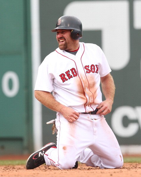 BOSTON, MA - APRIL 8:   Kevin Youkilis #20 of the Boston Red Sox smiles after being tagged out in a run down against the New York Yankees on Opening Day at Fenway Park on April 8, 2011 in Boston, Massachusetts. (Photo by Jim Rogash/Getty Images)