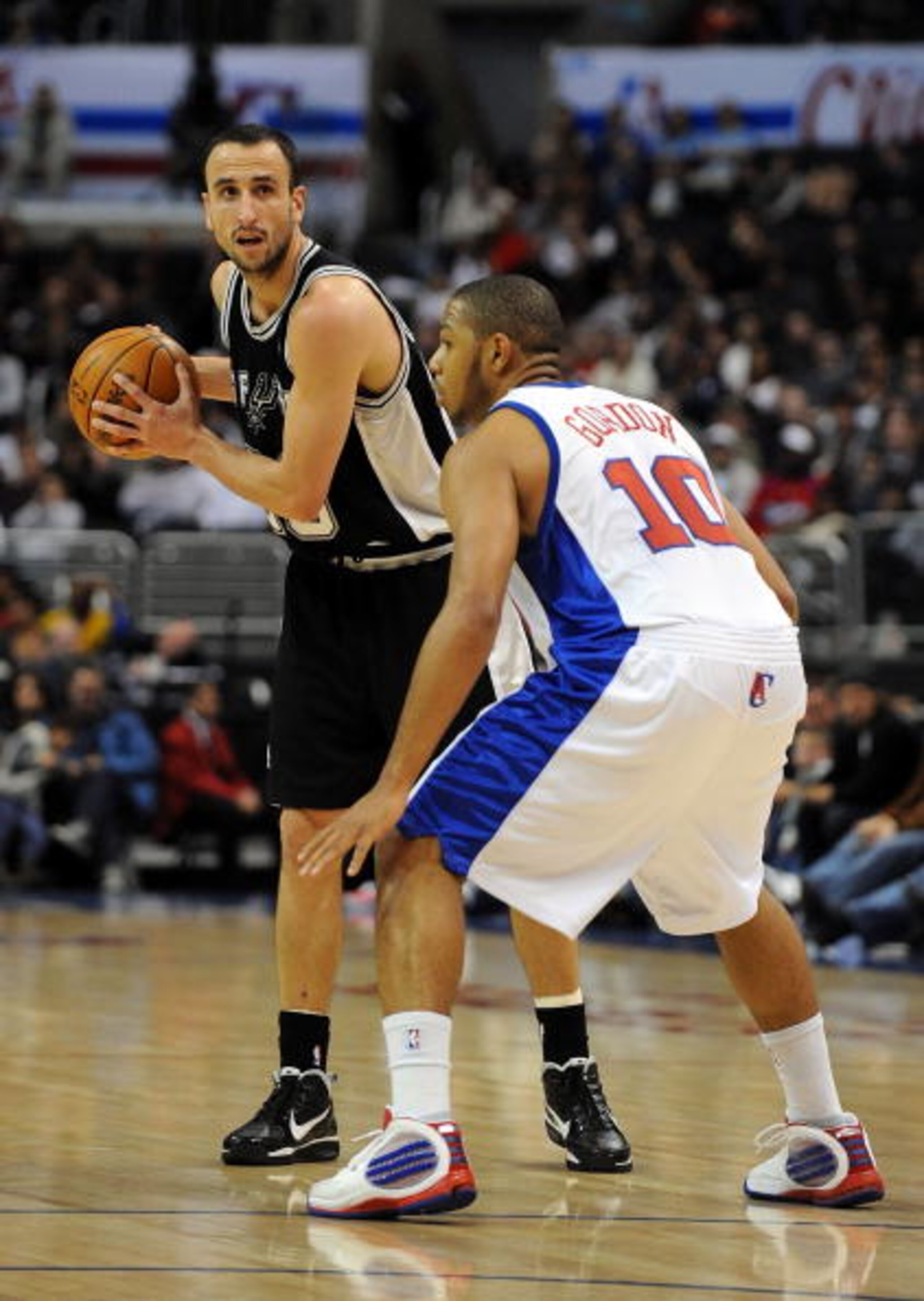 LOS ANGELES, CA - DECEMBER 13: Manu Ginobli #20 of the San Antonio Spurs waits to pass in front of Eric Gordon #10 of the Los Angeles Clippers at Staples Center on December 13, 2009 in Los Angeles, California. NOTE TO USER: User expressly acknowledges a LOS ANGELES, CA - DECEMBER 13: Manu Ginobli #20 of the San Antonio Spurs waits to pass in front of Eric Gordon #10 of the Los Angeles Clippers at Staples Center on December 13, 2009 in Los Angeles, California. NOTE TO USER: User expressly acknowledges a