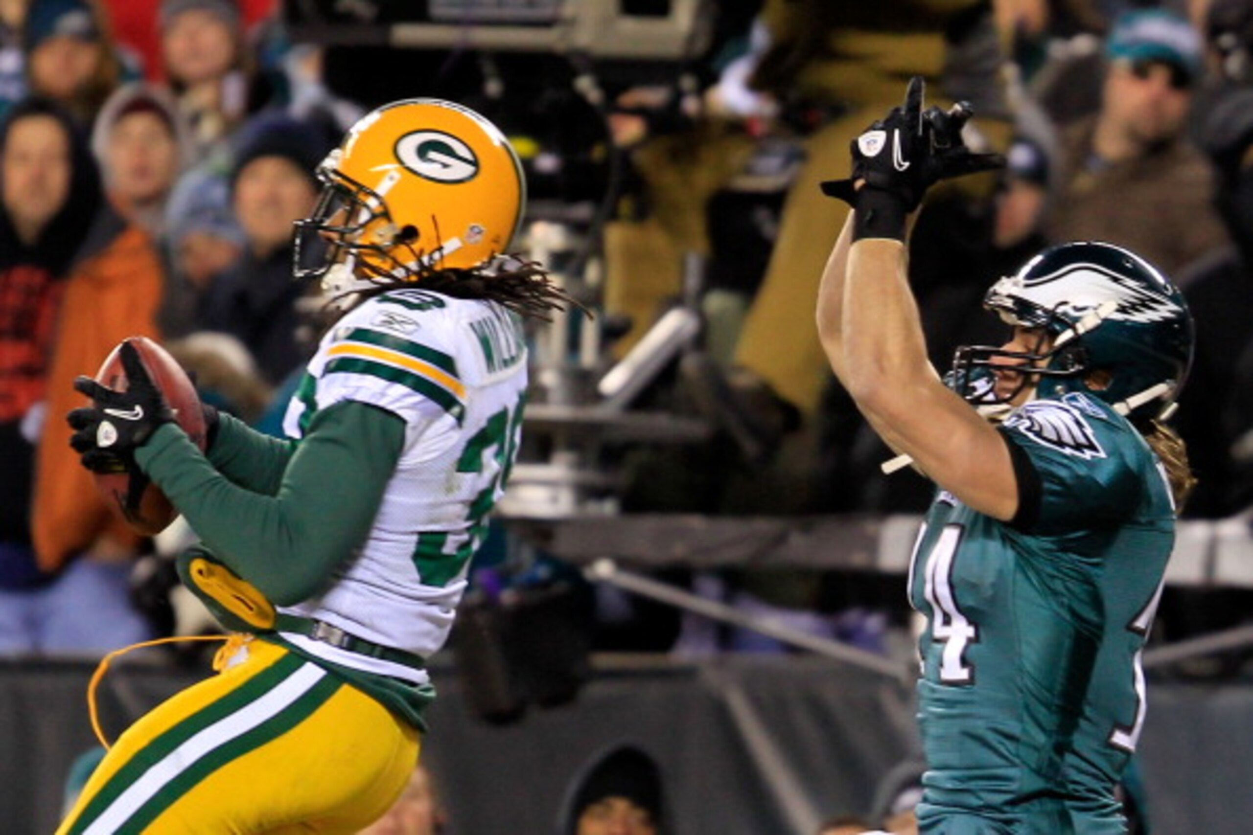 PHILADELPHIA, PA - JANUARY 09:  Tramon Williams #38 of the Green Bay Packers intercepts the pass intended for Riley Cooper #14 of the Philadelphia Eagles late in the fourth quarter during the 2011 NFC wild card playoff game at Lincoln Financial Field on J