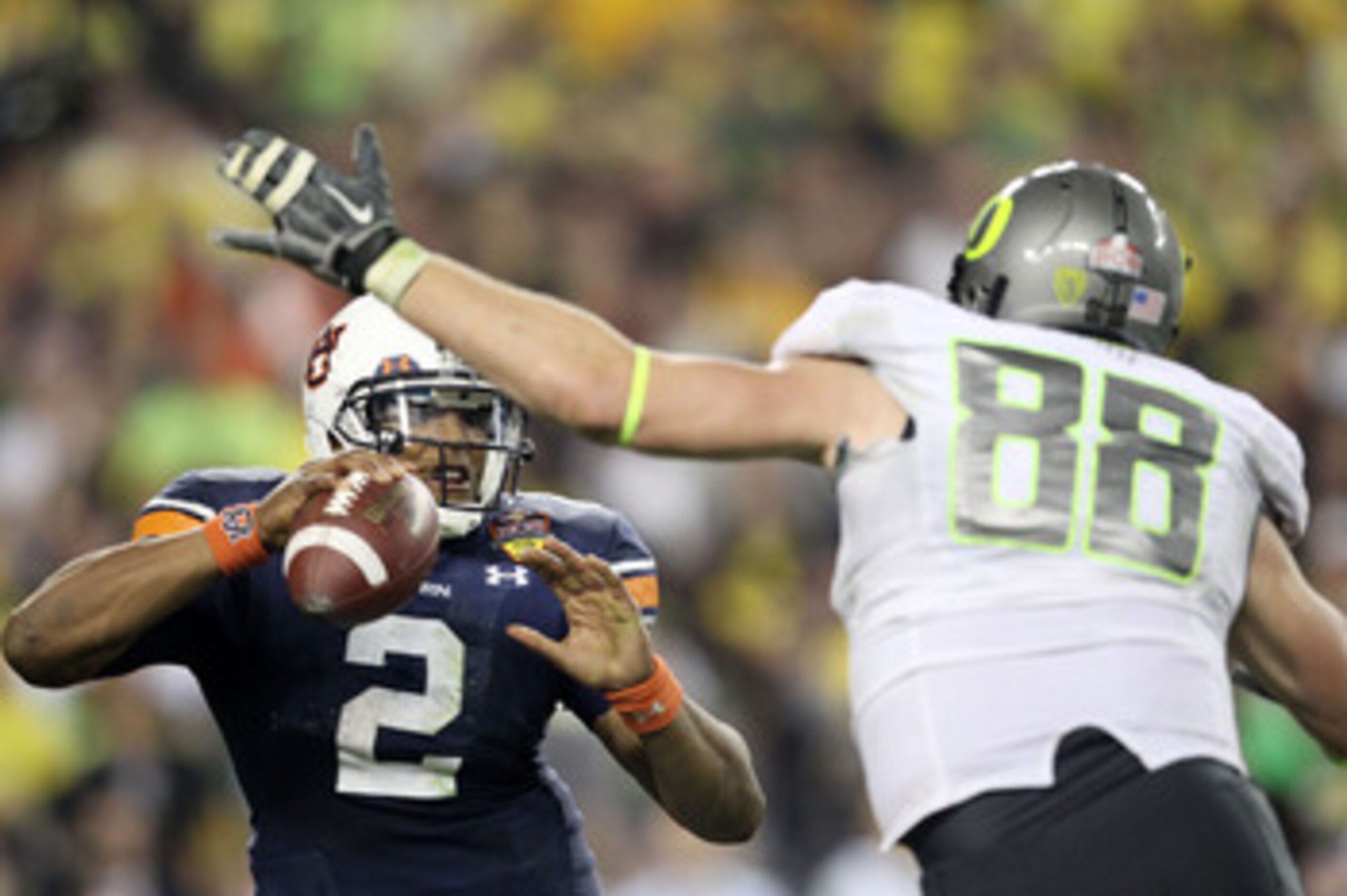GLENDALE, AZ - JANUARY 10: Cameron Newton #2 of the Auburn Tigers scrambles against Brandon Bair #88 of the Oregon Ducks during the Tostitos BCS National Championship Game at University of Phoenix Stadium on January 10, 2011 in Glendale, Arizona. (Photo GLENDALE, AZ - JANUARY 10: Cameron Newton #2 of the Auburn Tigers scrambles against Brandon Bair #88 of the Oregon Ducks during the Tostitos BCS National Championship Game at University of Phoenix Stadium on January 10, 2011 in Glendale, Arizona. (Photo