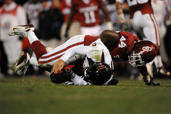 NORMAN, OK - NOVEMBER 22:  Quarterback Graham Harrell #6 of the Texas Tech Red Raiders is tackled by Jeremy Beal #44 of the Oklahoma Sooners at Memorial Stadium on November 22, 2008 in Norman, Oklahoma.  (Photo by Ronald Martinez/Getty Images)