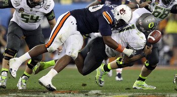 GLENDALE, AZ - JANUARY 10: Nick Fairley #90 of the Auburn Tigers sacks Darron Thomas #1 of the Oregon Ducks in the fourth quarter of the Tostitos BCS National Championship Game at University of Phoenix Stadium on January 10, 2011 in Glendale, Arizona. (Ph