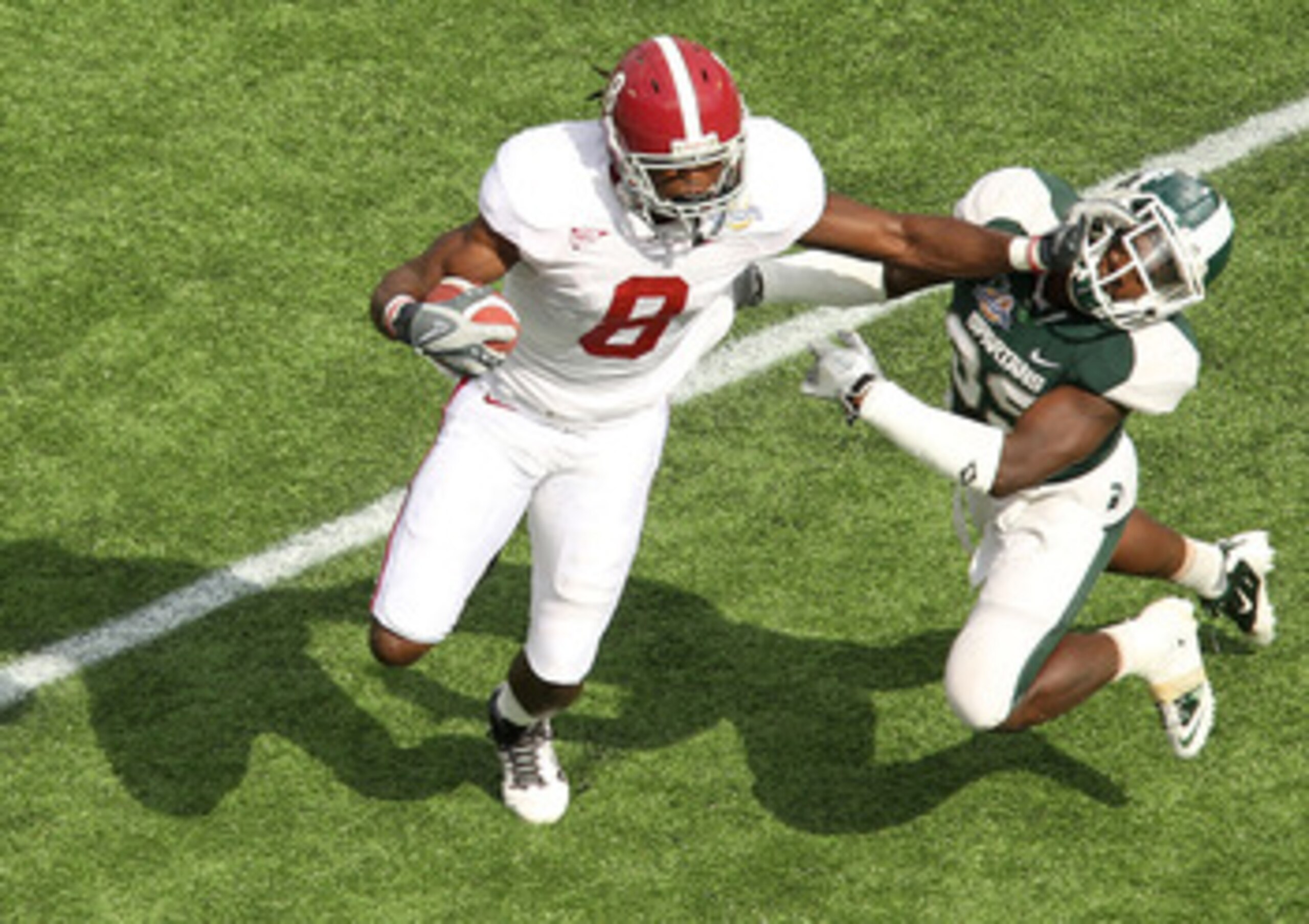 ORLANDO, FL - JANUARY 01: Julio Jones #8 of the Alabama Crimson Tide stiffarms Chris Rucker #29 of the Michigan State Spartans during the Capitol One Bowl at the Florida Citrus Bowl on January 1, 2011 in Orlando, Florida. (Photo by Mike Ehrmann/Getty Im ORLANDO, FL - JANUARY 01: Julio Jones #8 of the Alabama Crimson Tide stiffarms Chris Rucker #29 of the Michigan State Spartans during the Capitol One Bowl at the Florida Citrus Bowl on January 1, 2011 in Orlando, Florida. (Photo by Mike Ehrmann/Getty Im