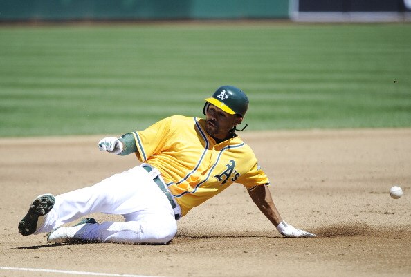 OAKLAND, CA - APRIL 3: Coco Crisp #4 of the Oakland Athletics slides into third-base safe after hitting an rbi triple in the second inning against the Seattle Mariners during a MLB baseball game at the Oakland-Alameda County Coliseum April 3, 2011 in Oakl