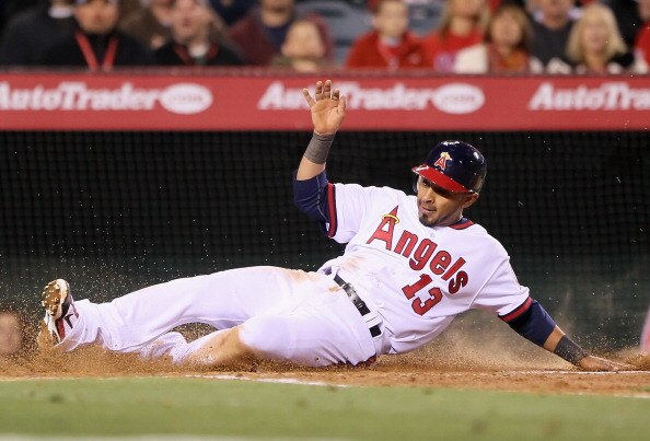 ANAHEIM, CA - APRIL 08:  Maicer Izturis #13 of the Los Angeles Angels of Anaheim slides safely across home plate and scores a run against the Toronto Blue Jays in the third inning at Angel Stadium of Anaheim on April 8, 2011 in Anaheim, California. The Bl