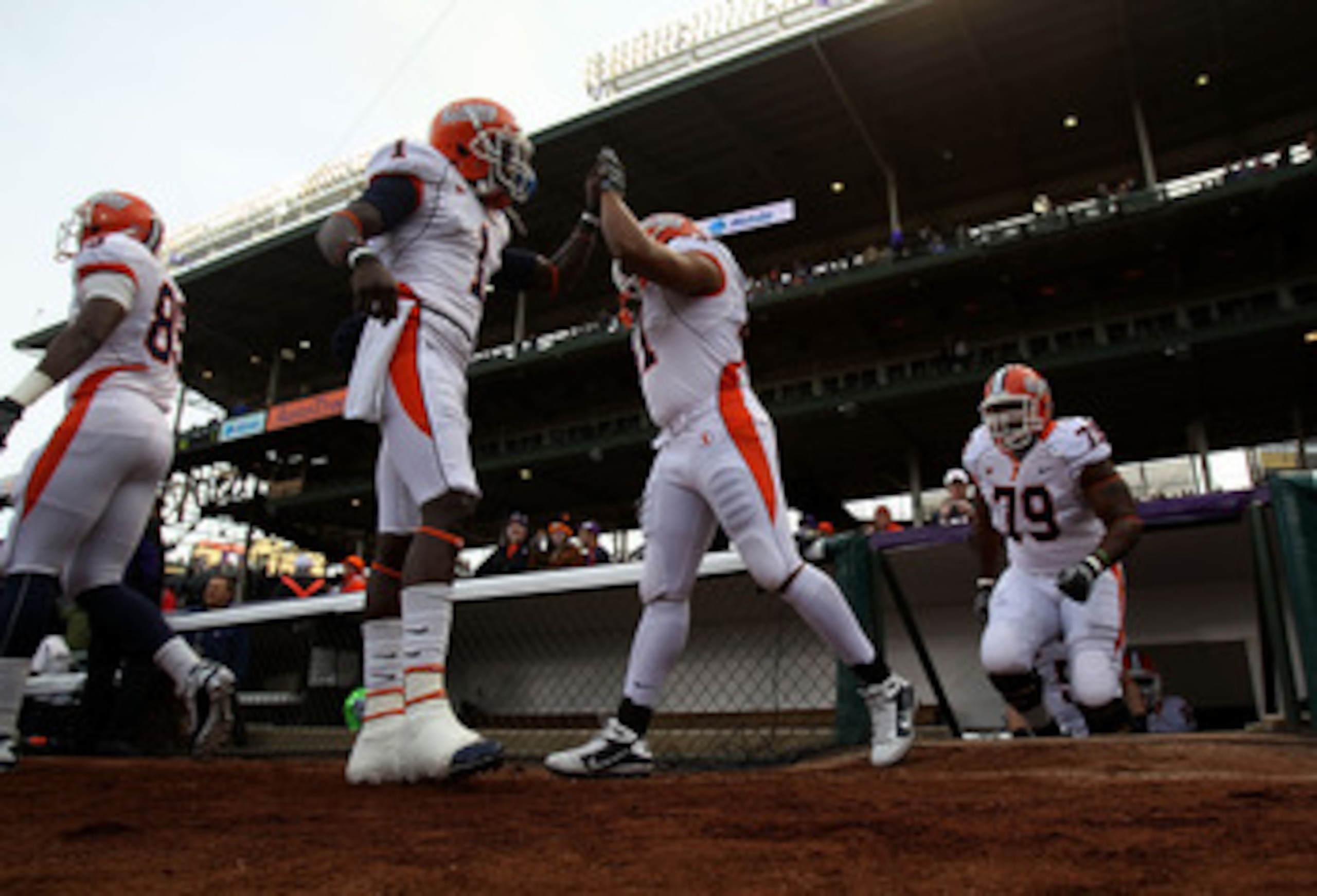 CHICAGO - NOVEMBER 20: Members of the Illinois Fighting Illini enter the field for warm-ups before a game against the Northwestern Wildcats played at Wrigley Field on November 20, 2010 in Chicago, Illinois. (Photo by Jonathan Daniel/Getty Images)