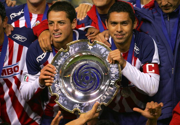 CARSON, CA - JANUARY 11:  Captain Ramon Morales #11 and Javier Hernandez #14 of CD Chivas de Guadalajara hold up the InterLiga trophy for a photo after defeating Morelia 4-2 on penalty kicks after a 1-1 draw in regulation during their InterLiga match at T