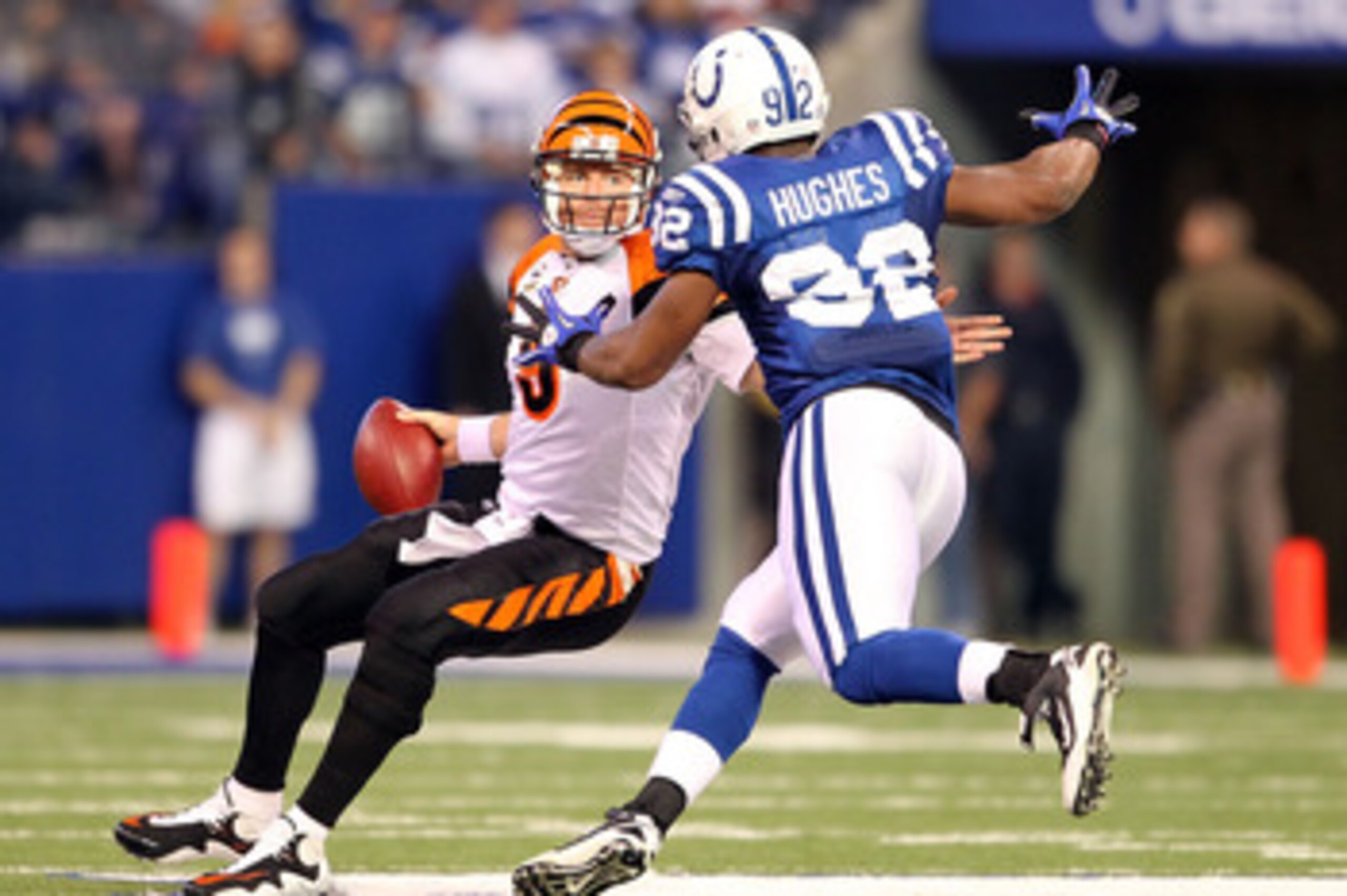 INDIANAPOLIS - NOVEMBER 14:  Carson Palmer #9 of the Cincinnati Bengals tries to avoid Jerry Hughes #92 of the Indianapolis Colts during the NFL game at Lucas Oil Stadium on November 14, 2010 in Indianapolis, Indiana. The Colts won 23-17.  (Photo by Andy